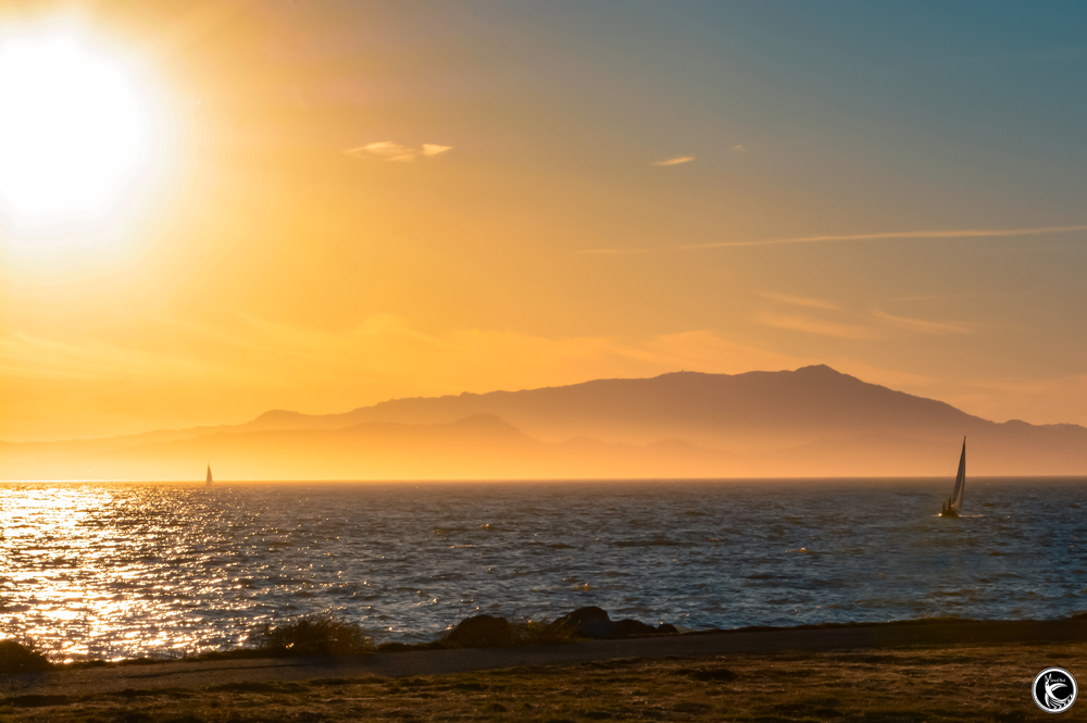 ManuOkai Photography Sunset Manrina Life sunset setting over ocean sail boats
