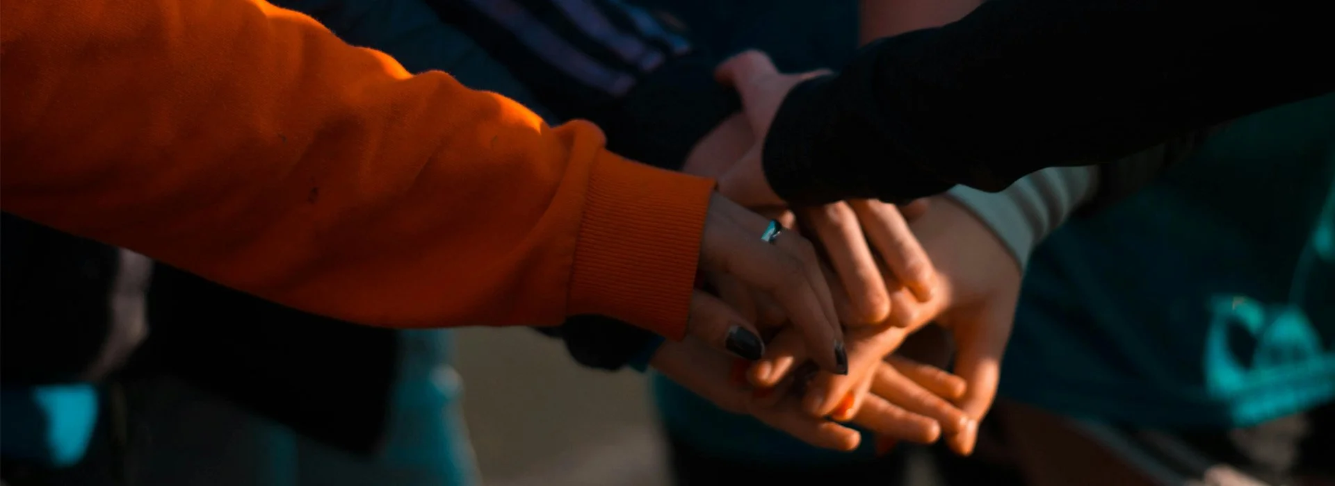 group of kids put hands in together