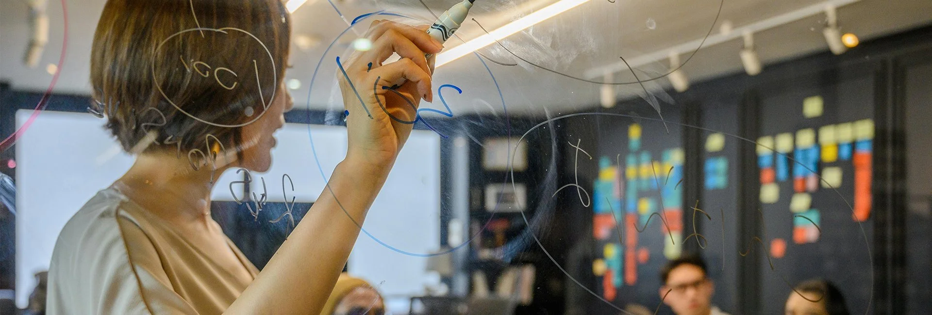 Woman writes on white board
