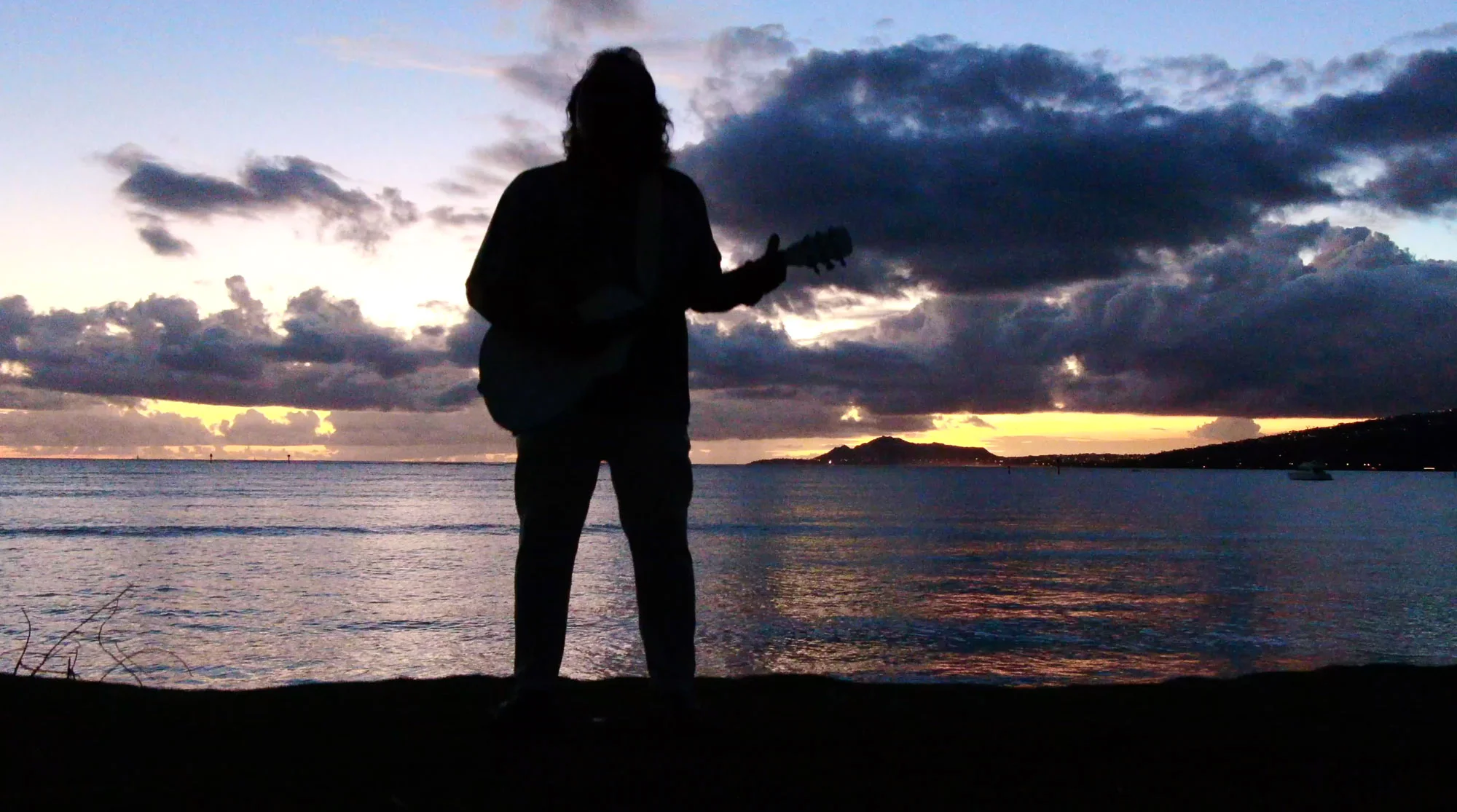 hksunsetbehindplayingguitar.jpg
