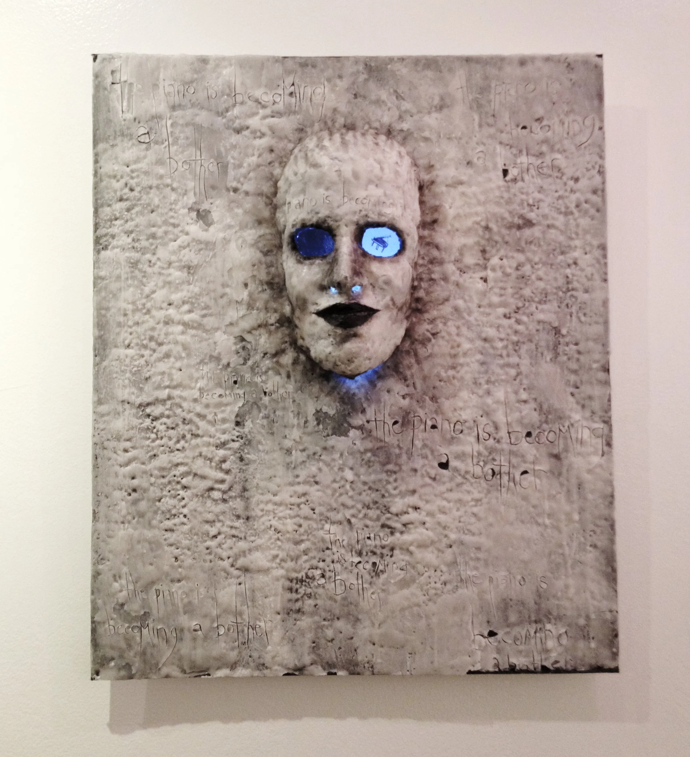  Age 17 - 2011 or 2012? - Encaustic wax painting, plaster, and other media on wood panel  Dug this up recently, and realized this piece was a self portrait of sorts (I used a plaster mold of my face). And that this very emo high school rendition dese