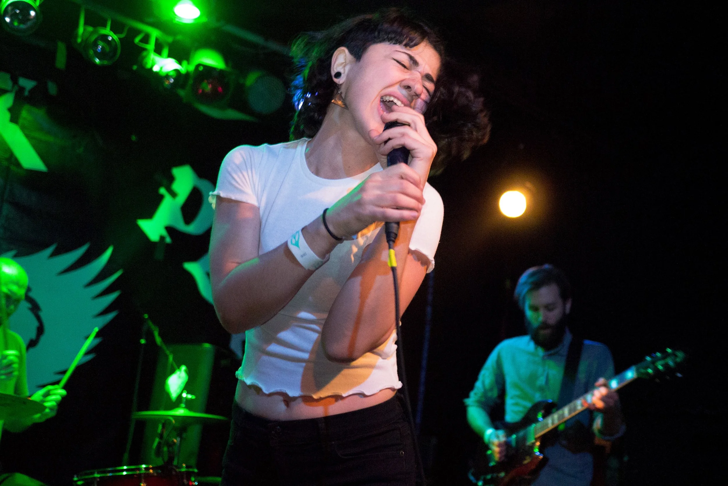 Female singer in a rock band screaming