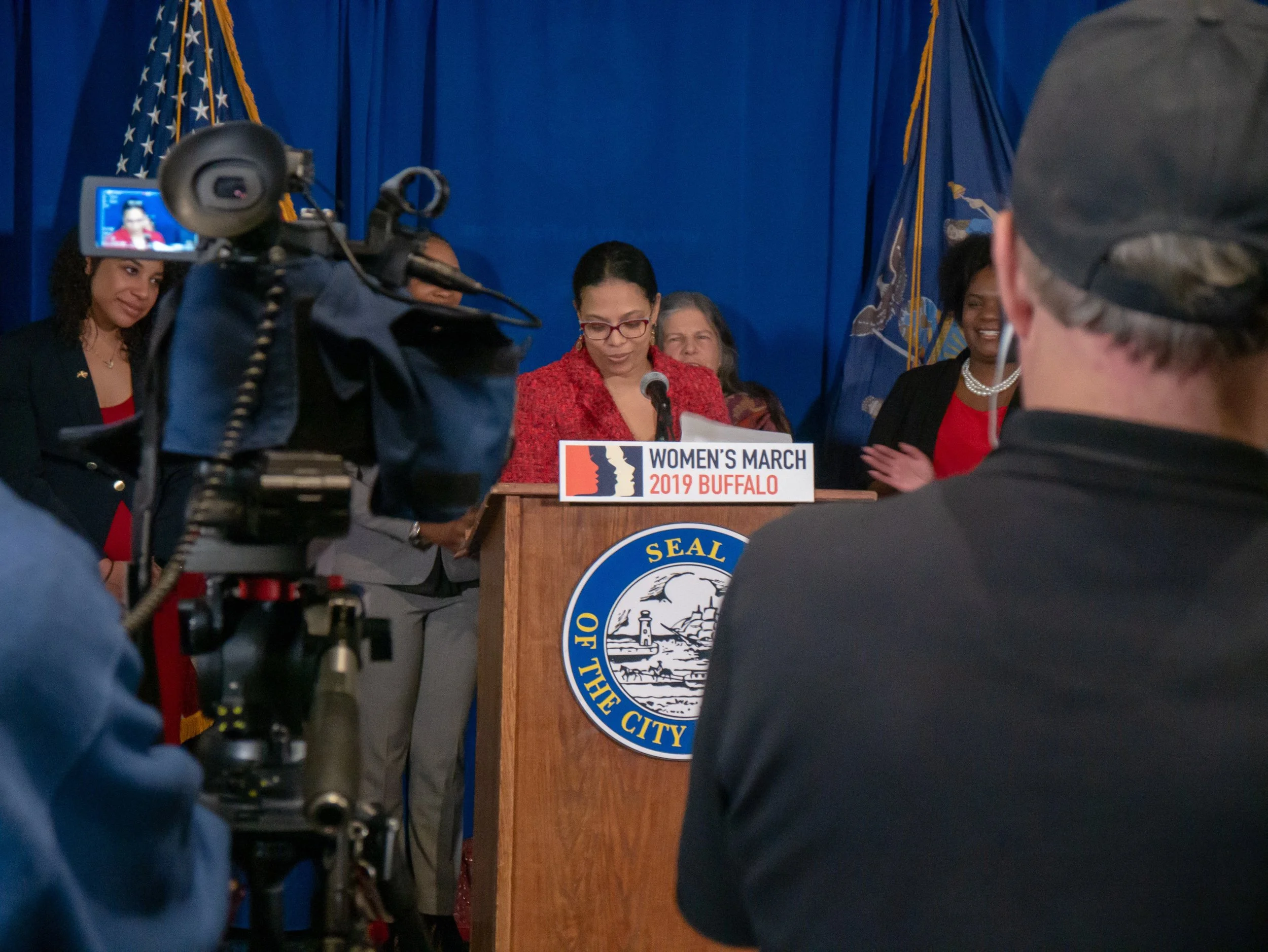 Woman politician at a press conference in front of cameras
