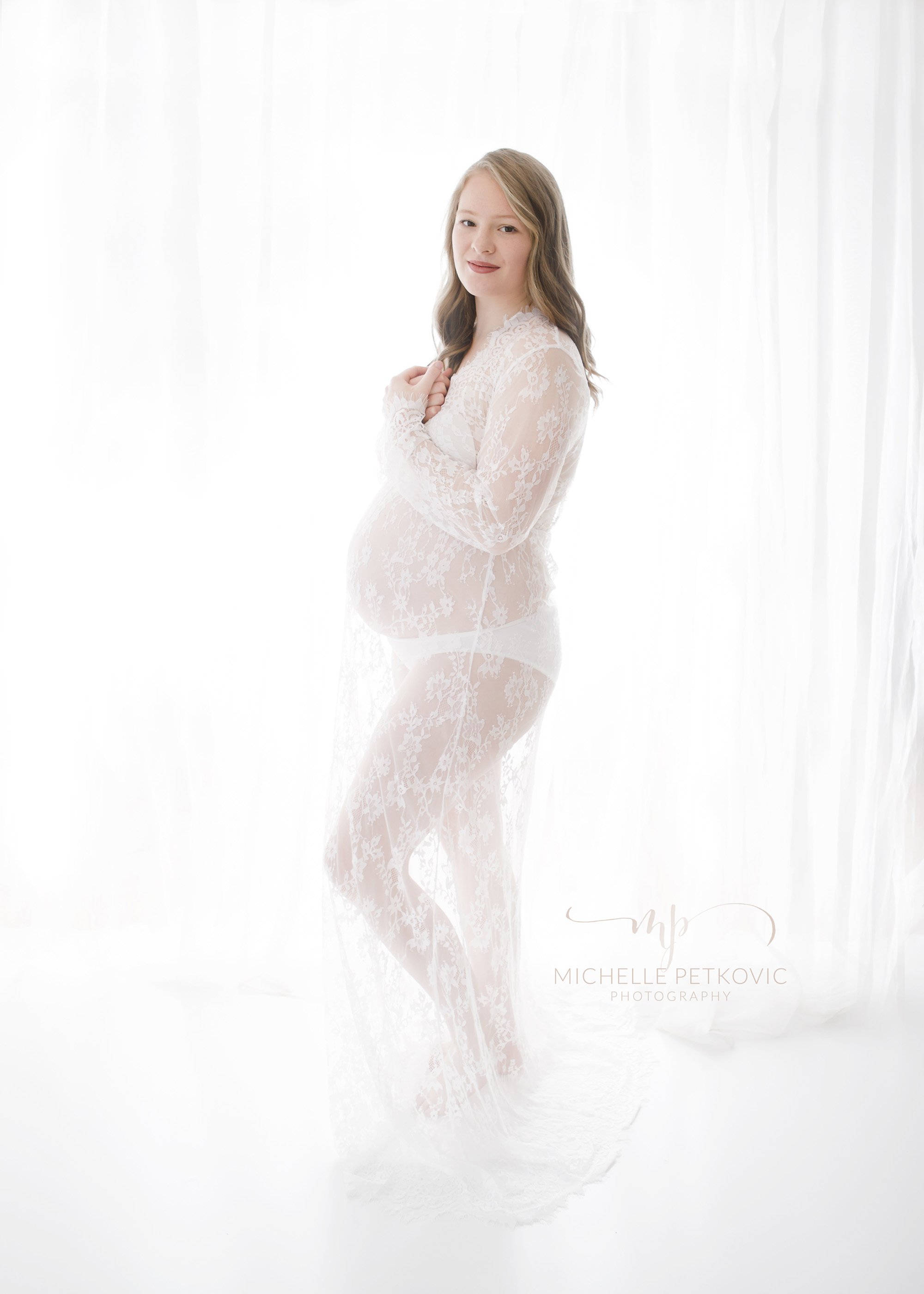  Floor length white lace maternity gown.  Size M but will stretch comfortably. BYO under garments 