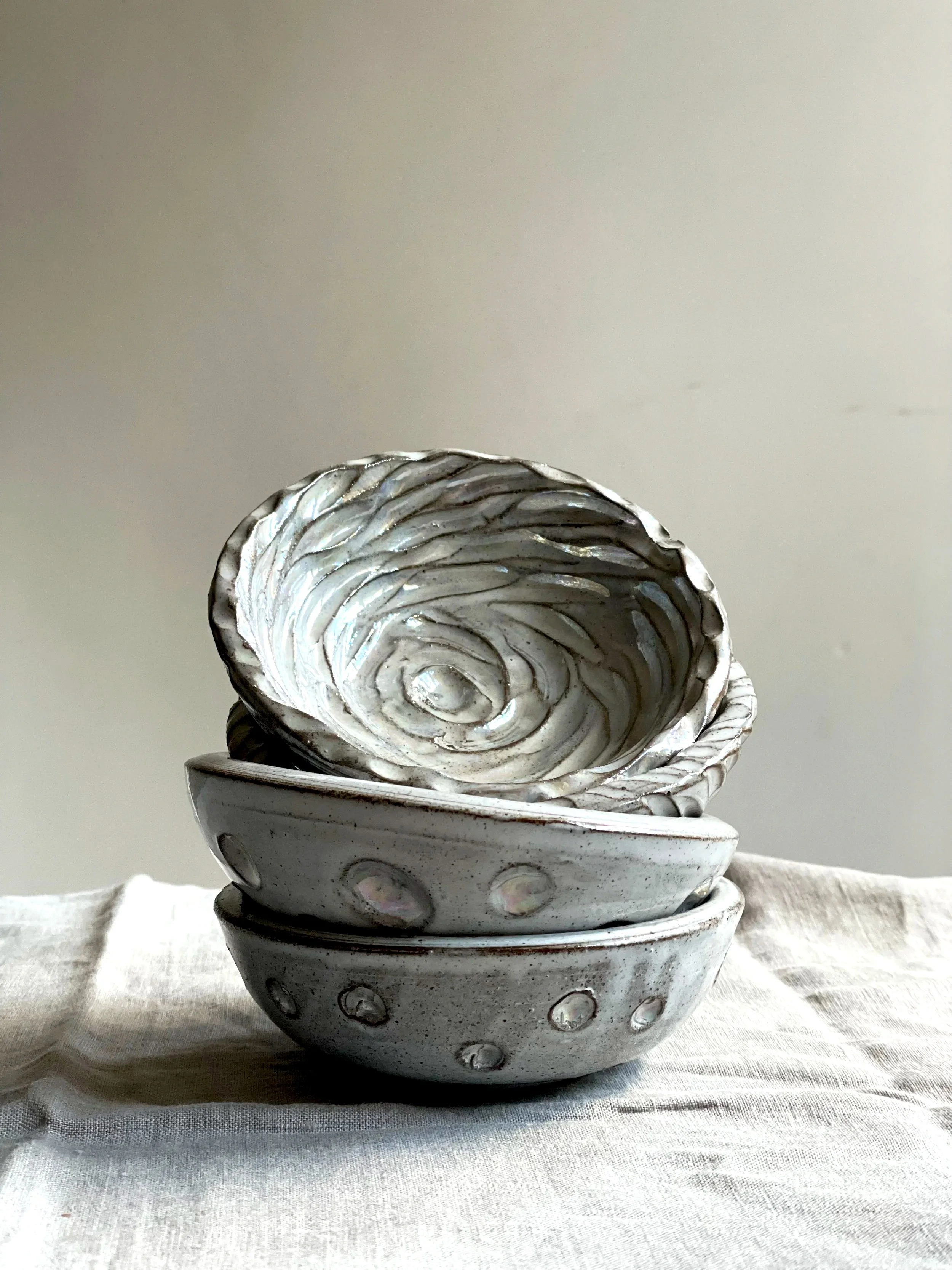 Stack of four hand-thrown terracotta bowls