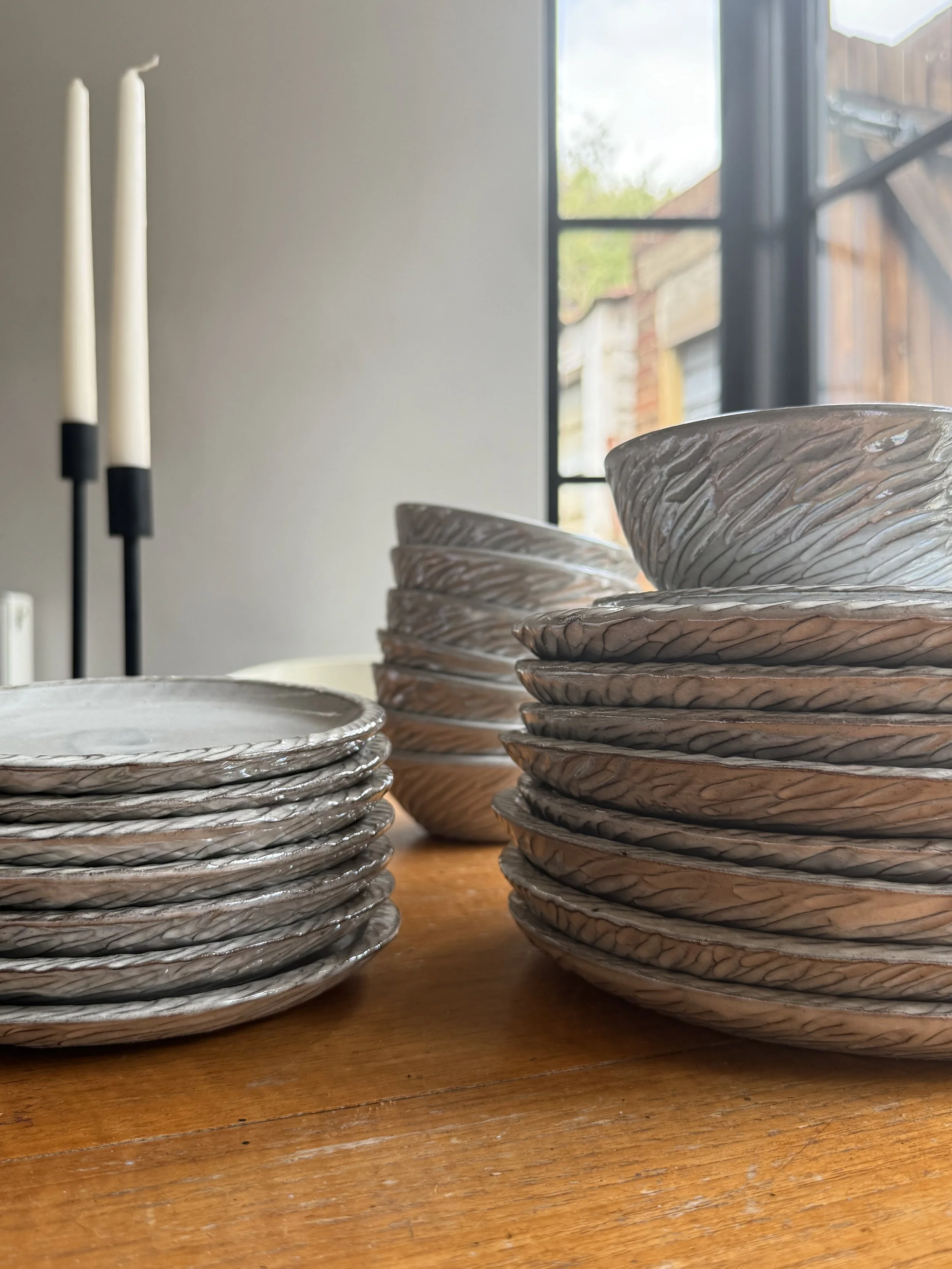 hand made pottery with mother of pearl detail. Pottery plates and bowls made to commission by Caroline Couzens