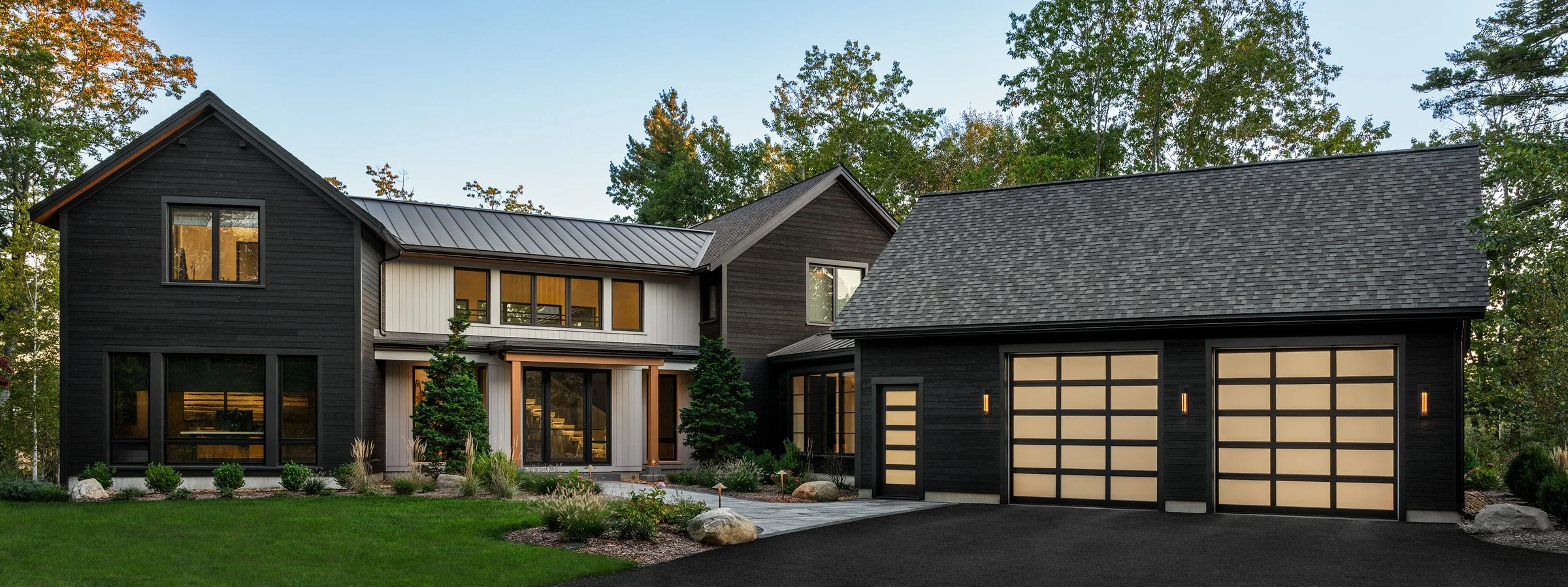  This contemporary home sits along a coastal marsh inlet and features Shou Sugi Ban treated wood siding—a Japanese charring technique that creates a dark, weather-resistant exterior. The design combines natural woods, metals, and glass to create warm