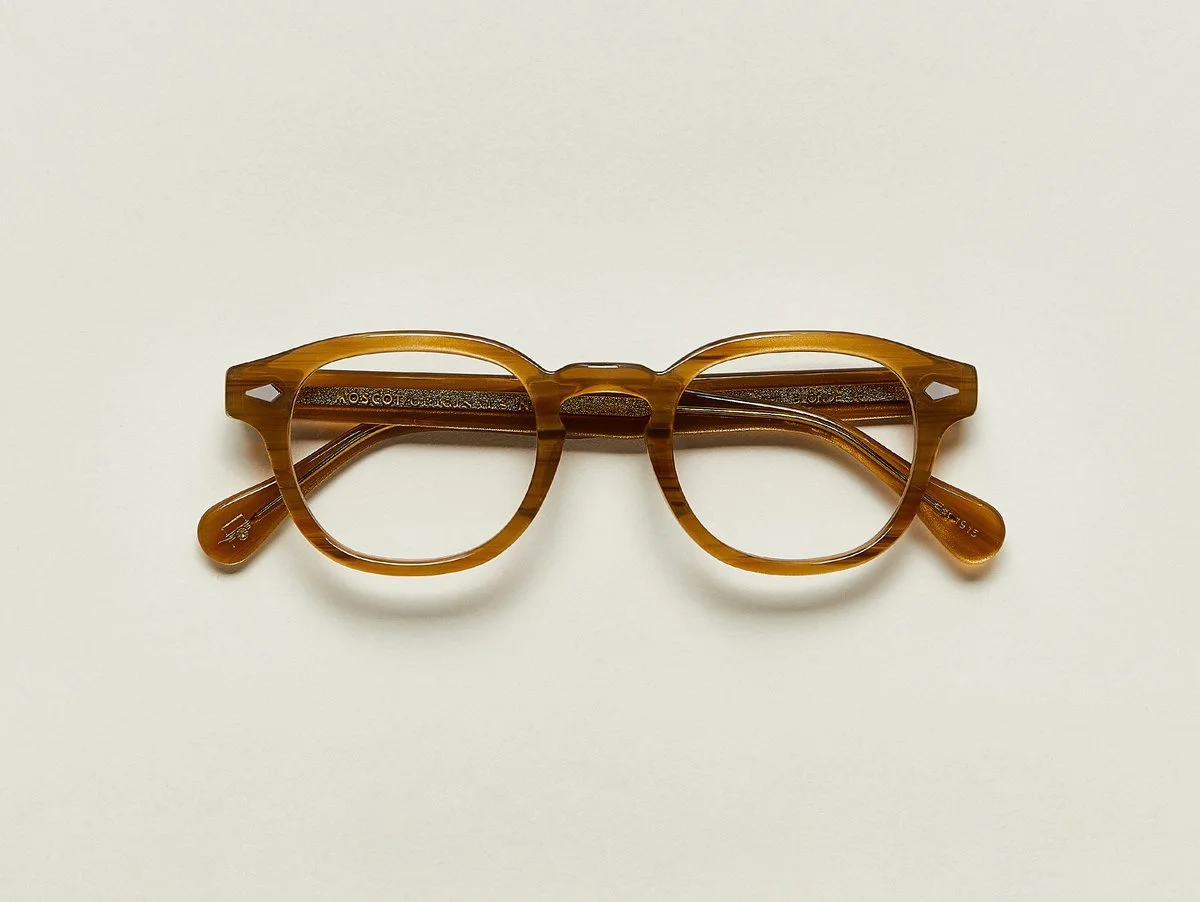 MOSCOT - Lemtosh Opticals £245 COLOUR Blonde SIZE 44 This rounder number has served as the calling card for generations of creative, thoughtful, free-spirited intellectuals and artistes – from James Dean to Johnny Depp. Handcrafted using Italian acetate featuring unique patterns distinctive to each frame Features diamond rivets Comfortable key hole nose bridge Includes acetate nose pads 7-Barrel hinge MOSCOT temple engravings Signature acetate tips