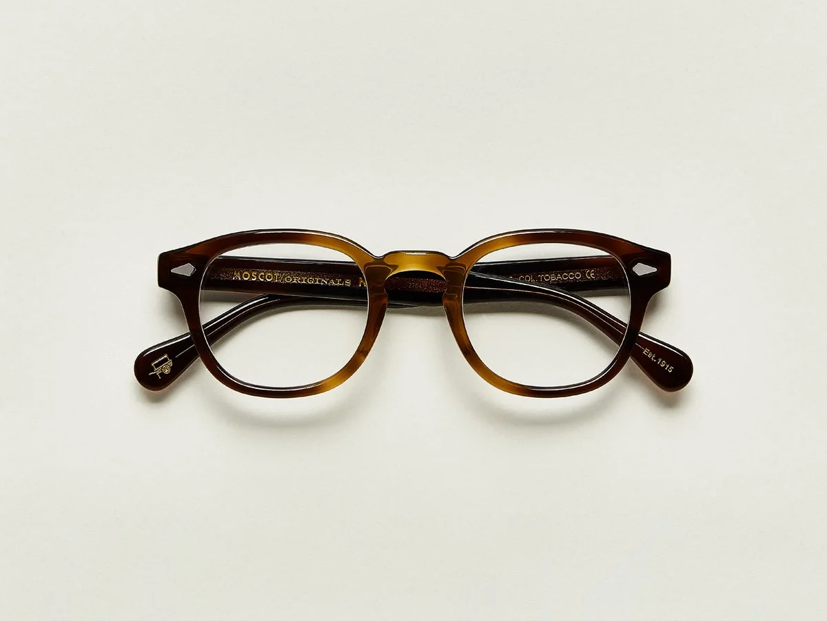 MOSCOT - Lemtosh Opticals £245 COLOUR Tobacco SIZE 49 This rounder number has served as the calling card for generations of creative, thoughtful, free-spirited intellectuals and artistes – from James Dean to Johnny Depp. Handcrafted using Italian acetate featuring unique patterns distinctive to each frame Features diamond rivets Comfortable key hole nose bridge Includes acetate nose pads 7-Barrel hinge MOSCOT temple engravings Signature acetate tips