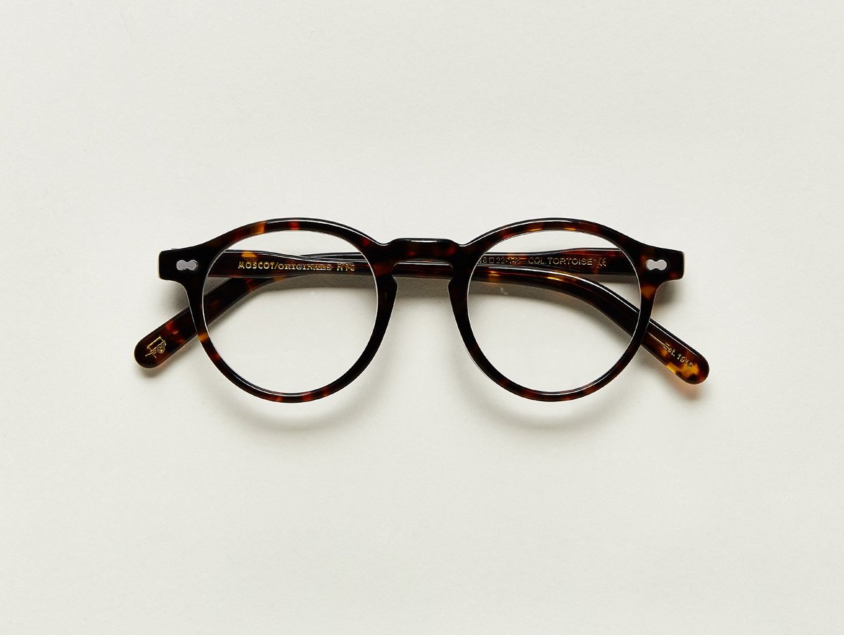 MOSCOT - Militzen Opticals £245 COLOUR Tortoise SIZE 46 The round, full-vue MILTZEN, first introduced in the 1930s, is eponymously named for our Uncle Heshy, who inexplicably everyone called Uncle Miltzen. And it stuck. So there you go, world... The MILTZEN. Handcrafted using Italian acetate Features adjoined dot rivets Comfortable key hole nose bridge Includes acetate nose pads 3-Barrel hinge MOSCOT temple engravings