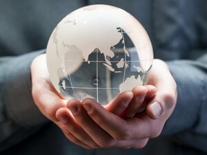 Glass globe in hands representing FutureLearn free online nature courses