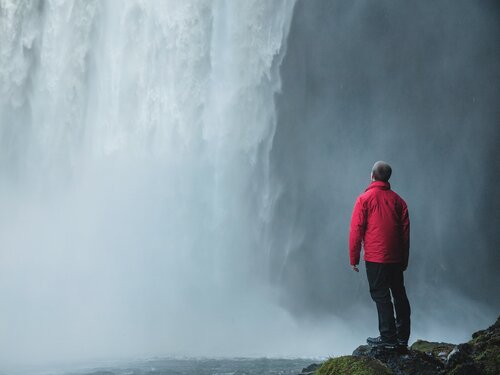 Person looking at a waterfall representing Alison free online sustainability courses
