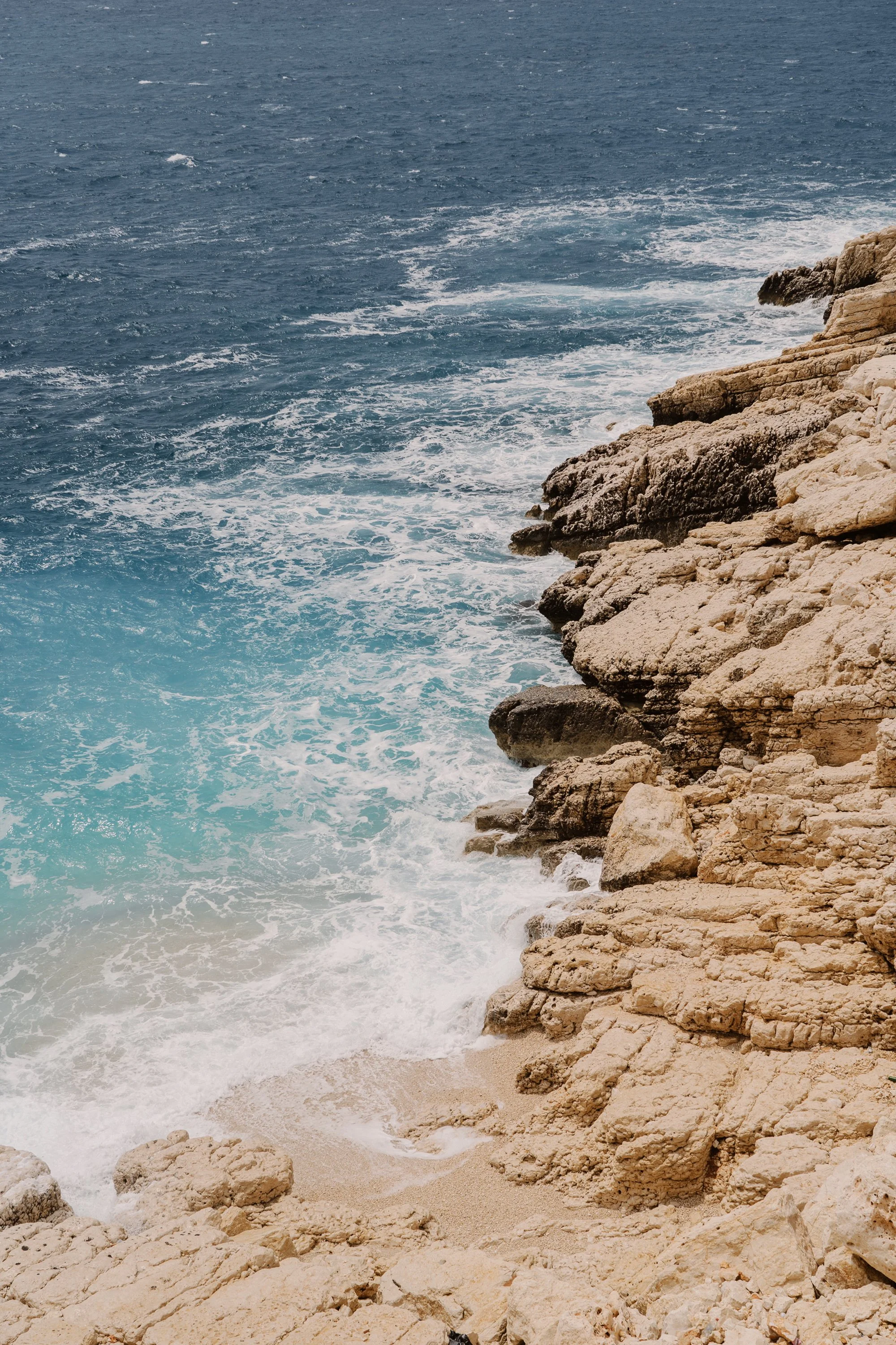 Rocky coastline and blue sea, representing the shift from digital overwhelm to a clearer way forward.