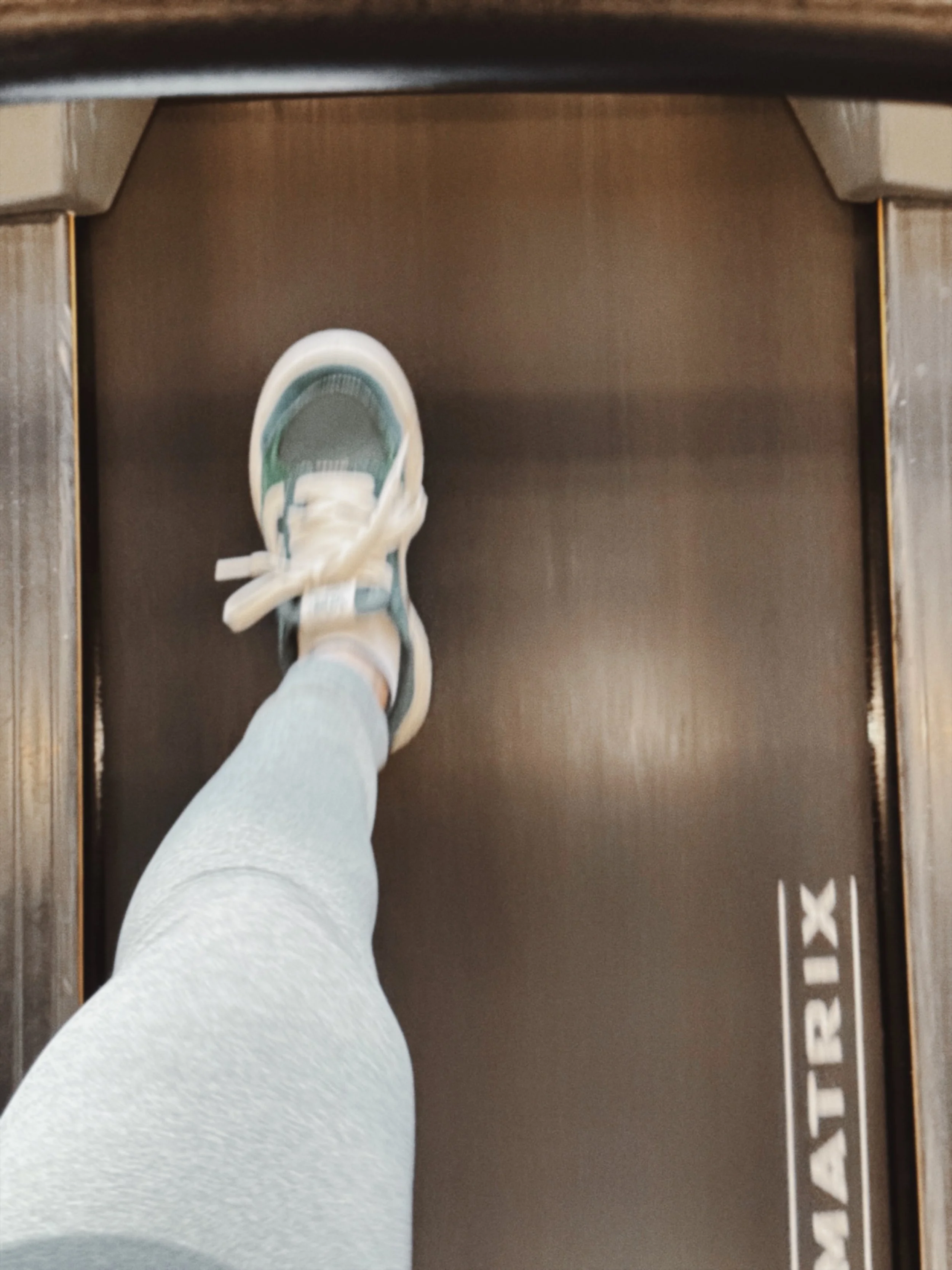 Person stepping forward in a white trainer on a wooden floor, symbolising a clearer next step for an eco-conscious brand.
