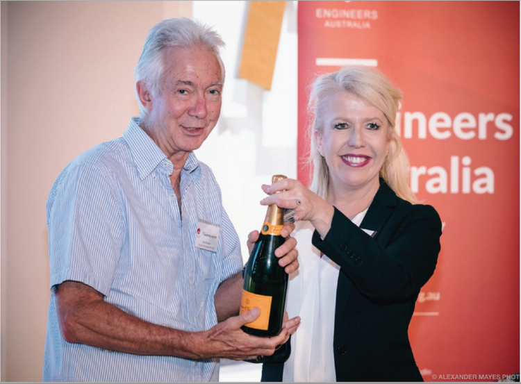 Gary Bullock MD of Protectiflex parent company receiving a bottle of champagne at a recent Engineers Australia event.