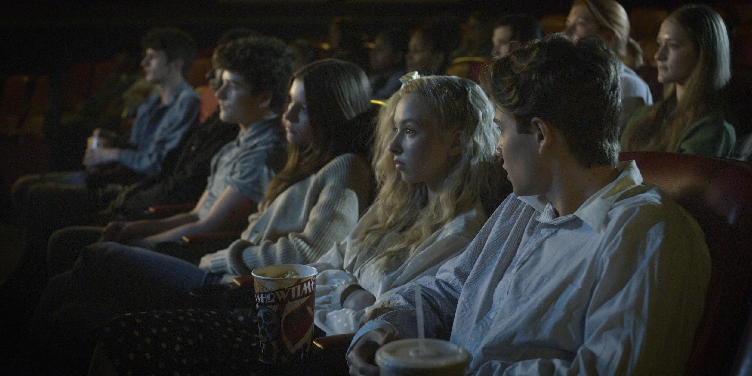 Audience watching a film screening in Going Viral narrative feature