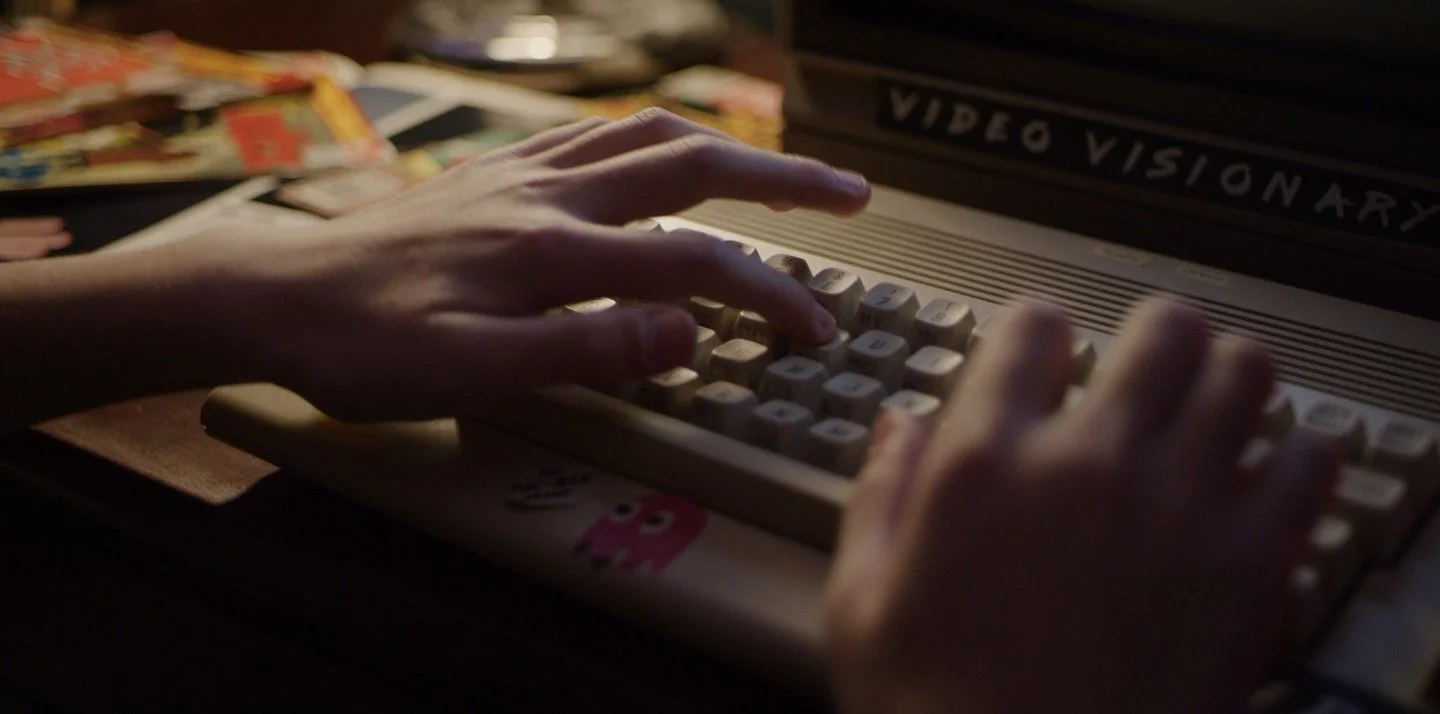 Still from Going Viral narrative feature - hands operating vintage video equipment