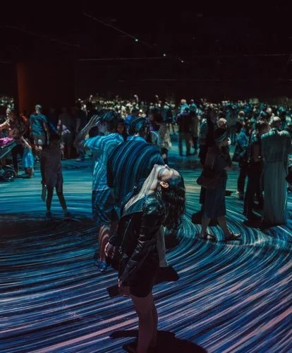 Woman looking up at a ceiling in a visual interactive display.jpeg