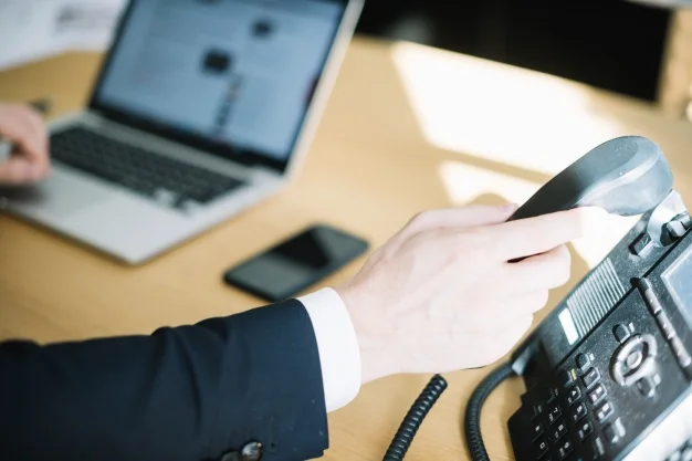 man-picking-up-phone-in-office_23-2147711001.jpg
