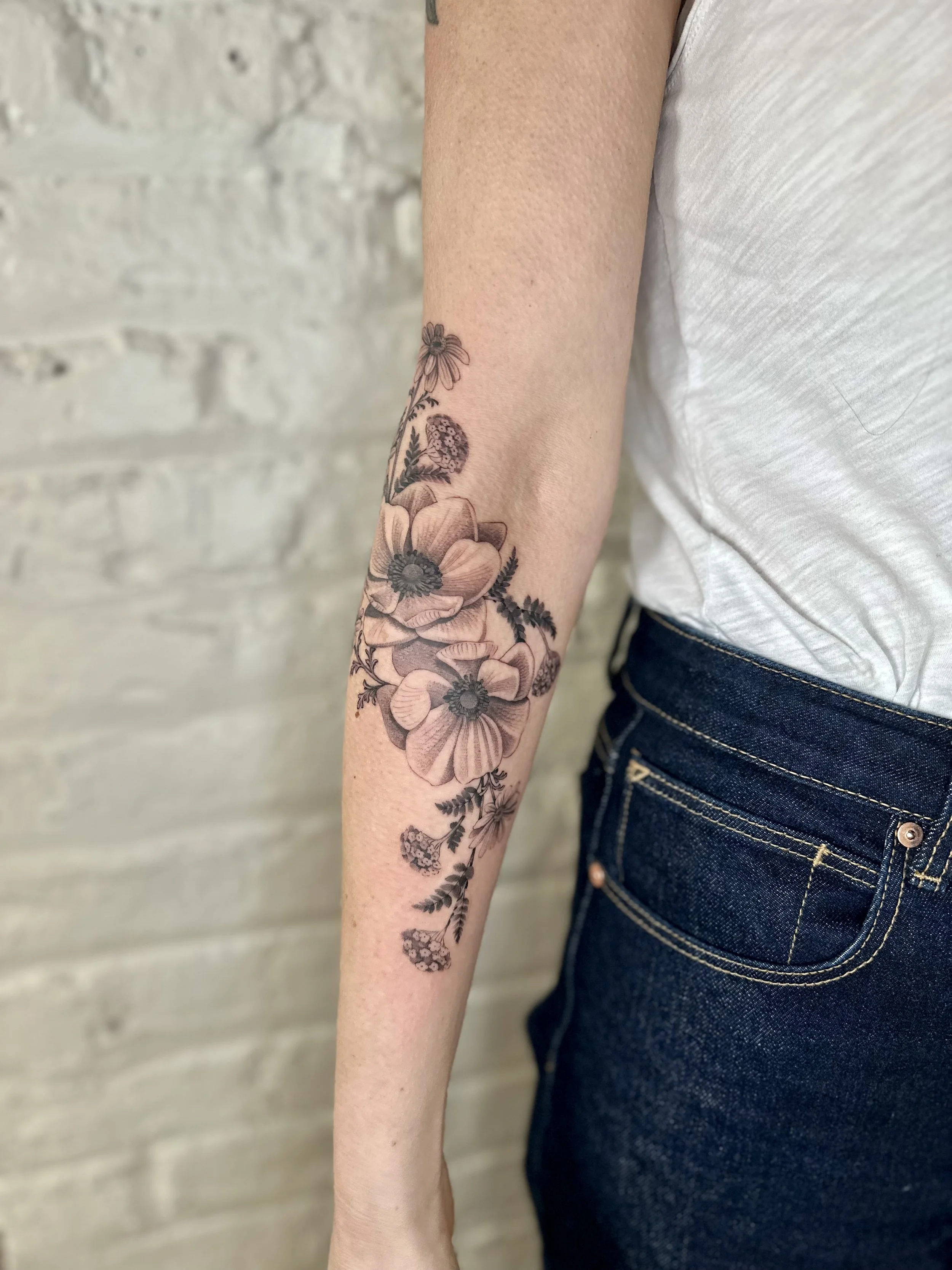 Black and Grey Fine Line Floral Tattoo with Anemones, Daisies, and Yarrow
