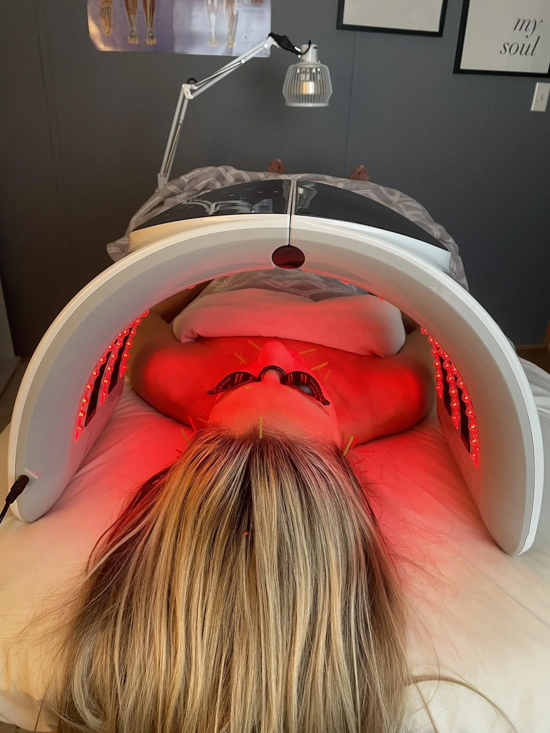 A client receiving red light therapy during her facial rejuvenation treatment