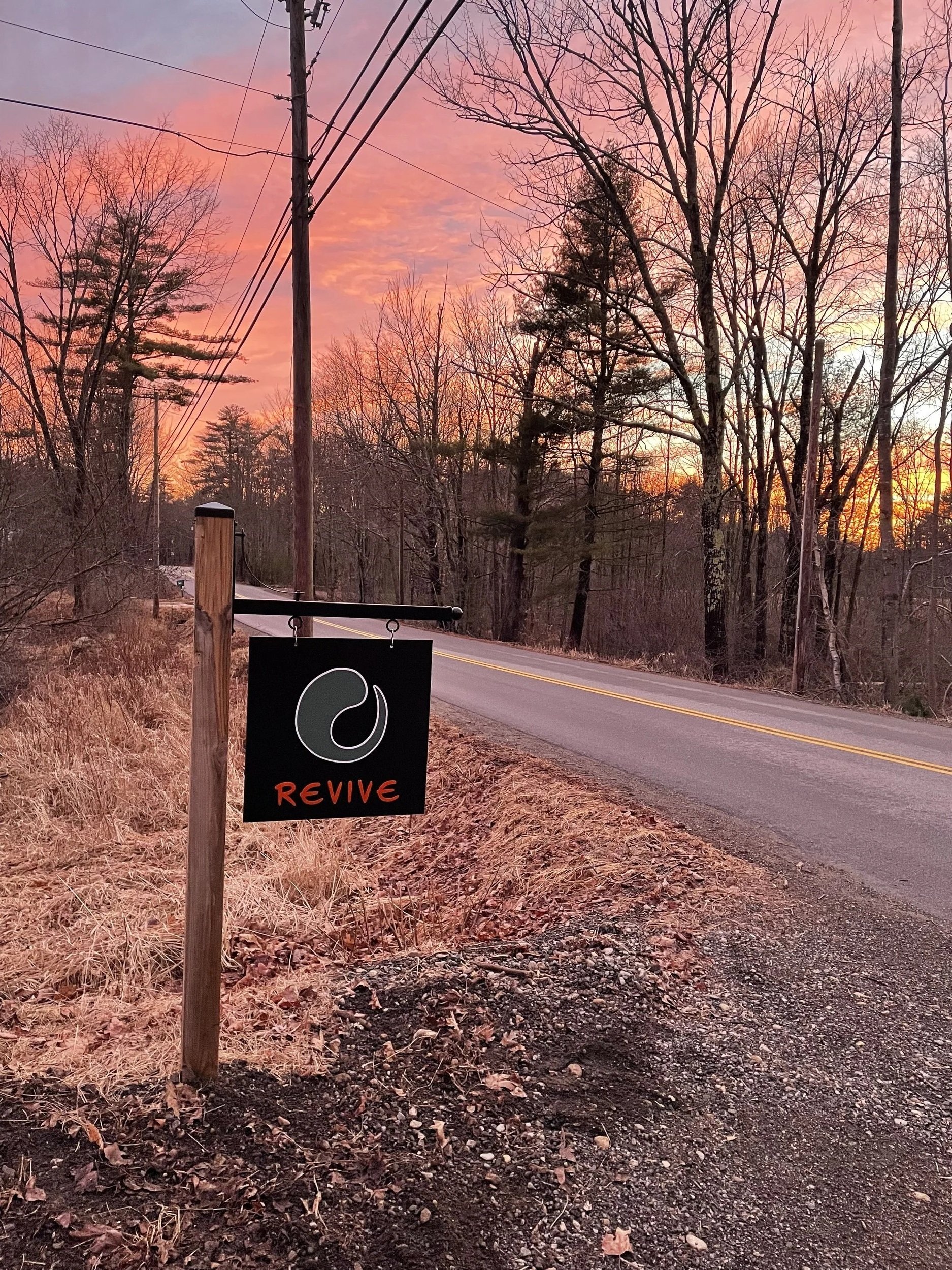 The sign at Revive during a beautiful sunset