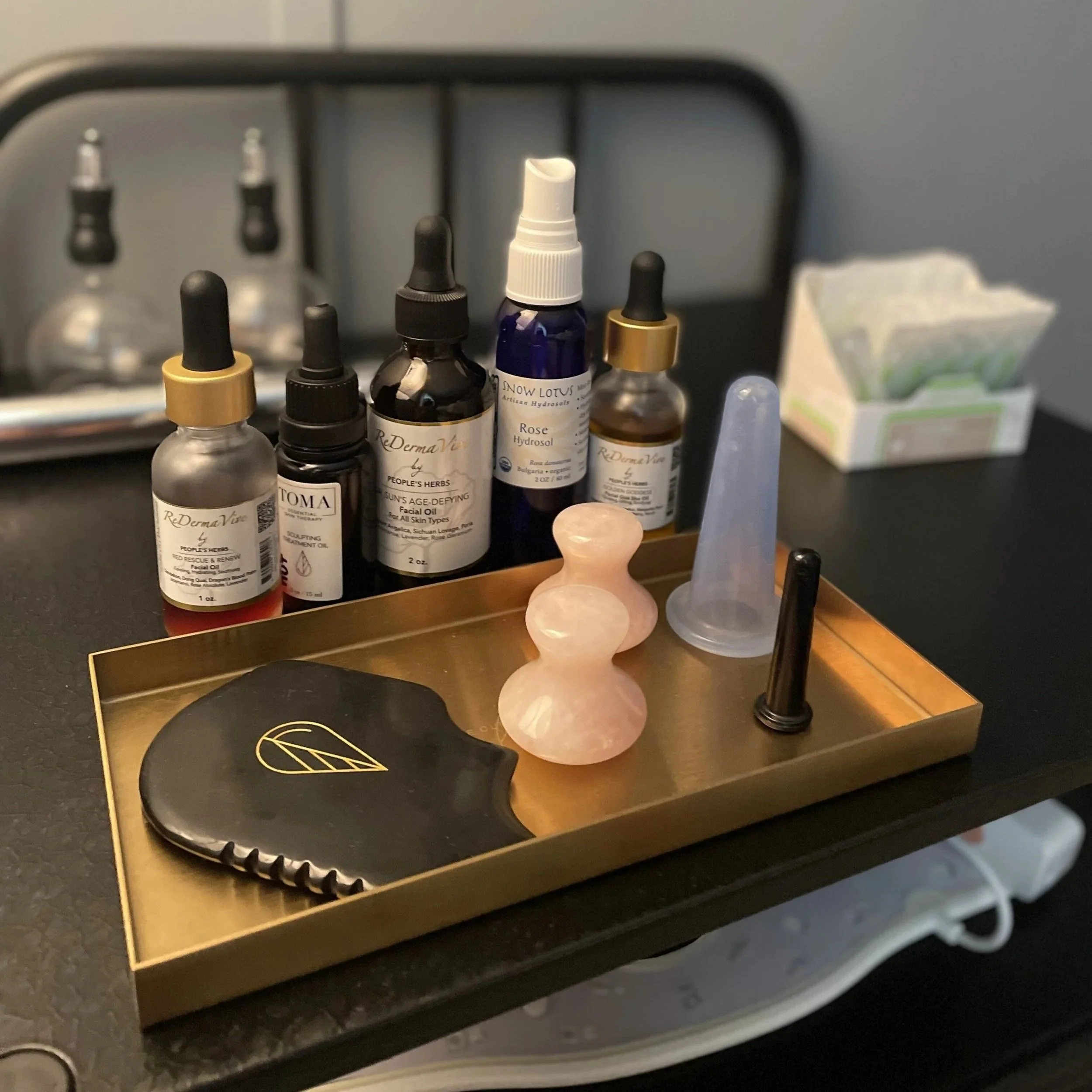 Facial cups, gua sha and salves using during our facial rejuvenation treatment