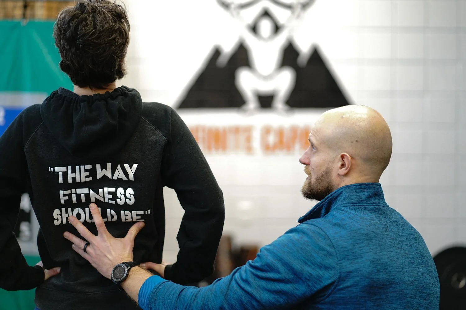 A performance physical therapist assessing a patient to determine the root cause of their problem.