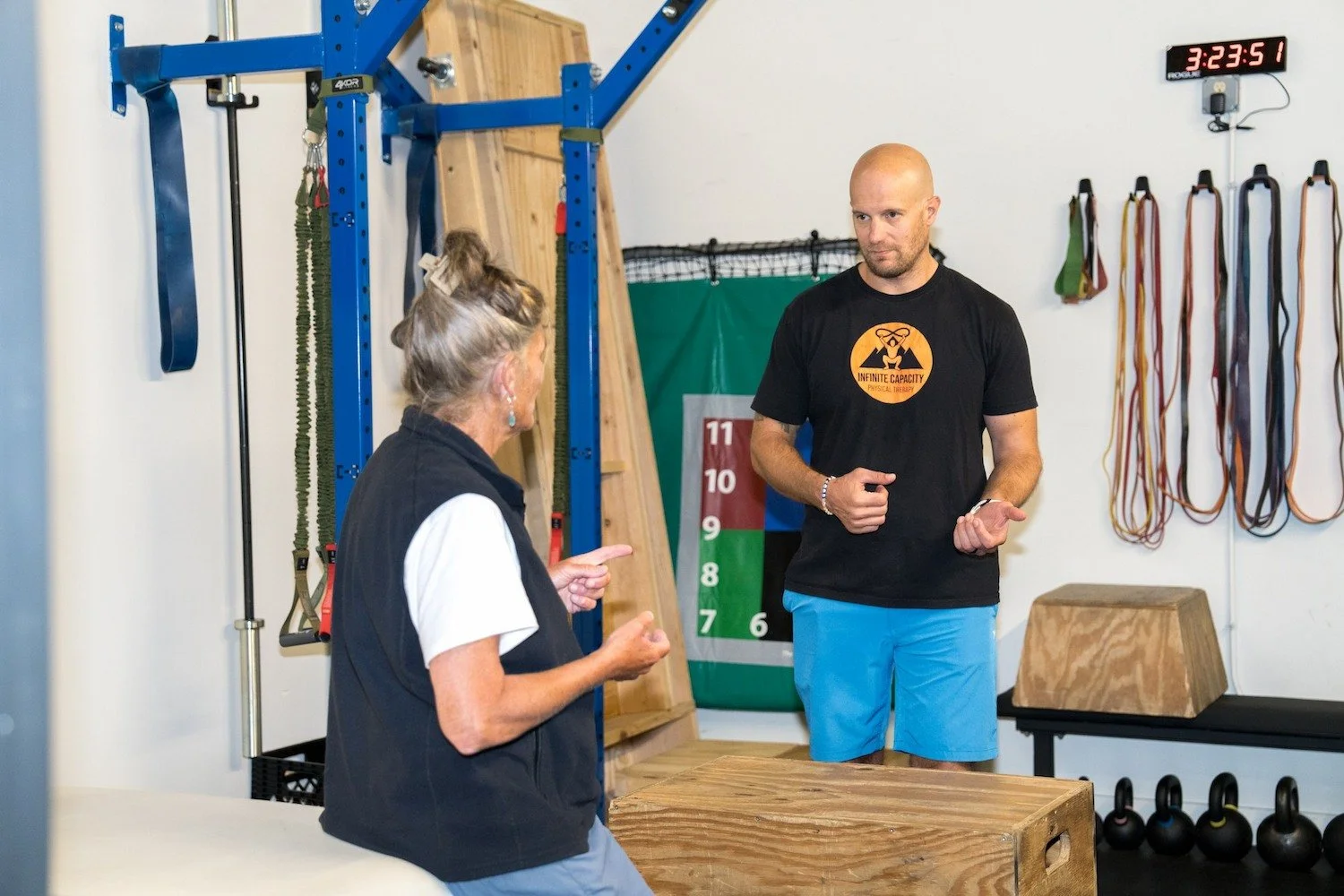 Sports physical therapist educating a patient during a treatment session.
