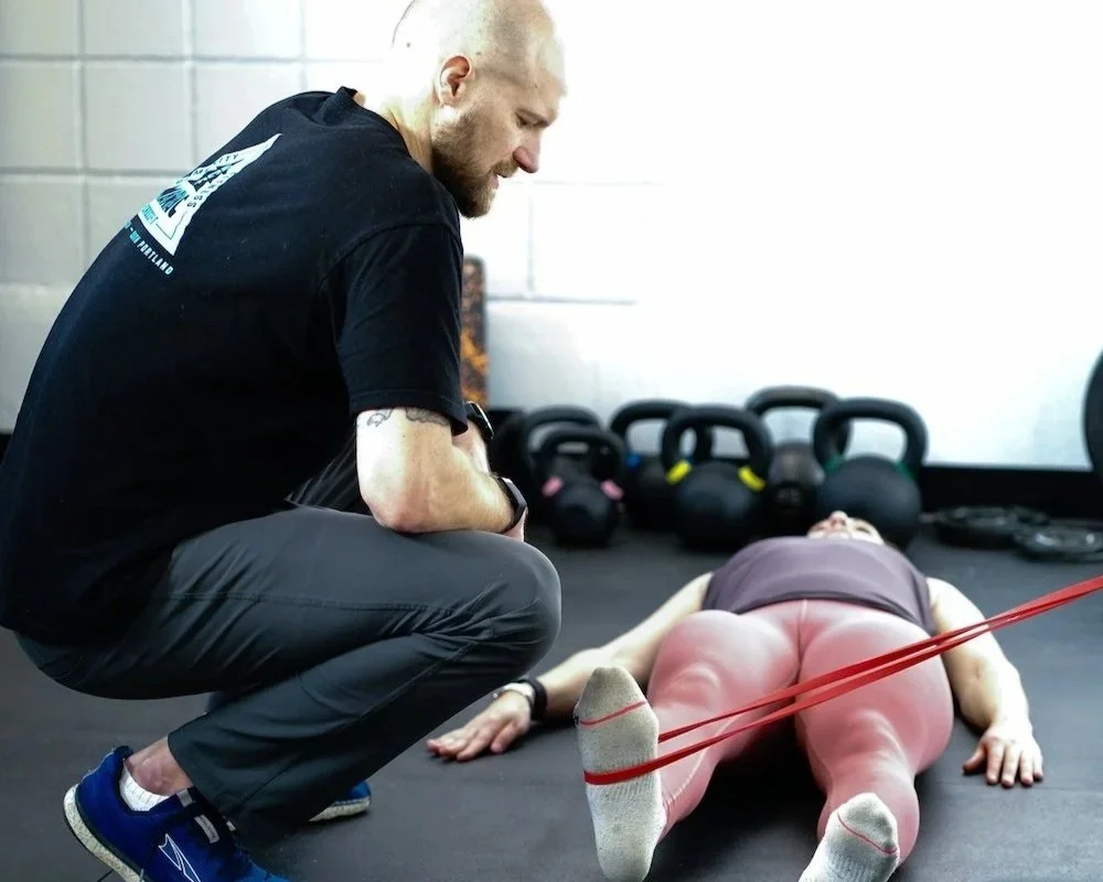 Sport physical therapist providing corrective exercises to an athlete to help fix the issue.