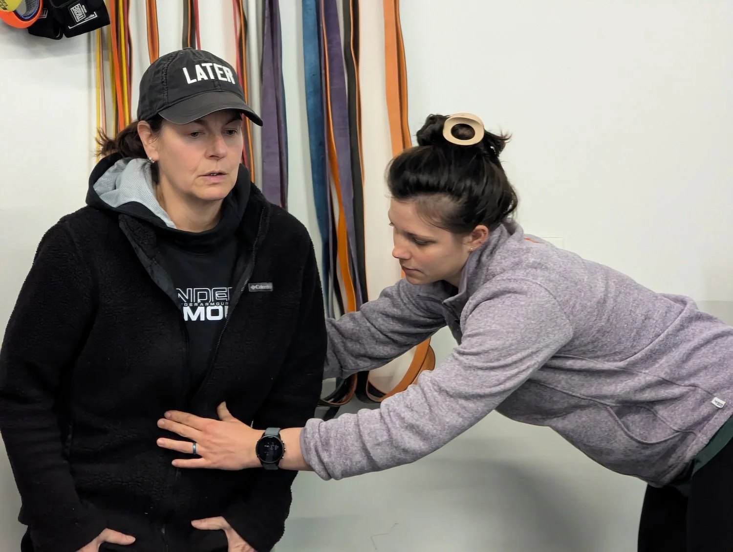 Pelvic floor therapist assisting a patient with core activation exercises.