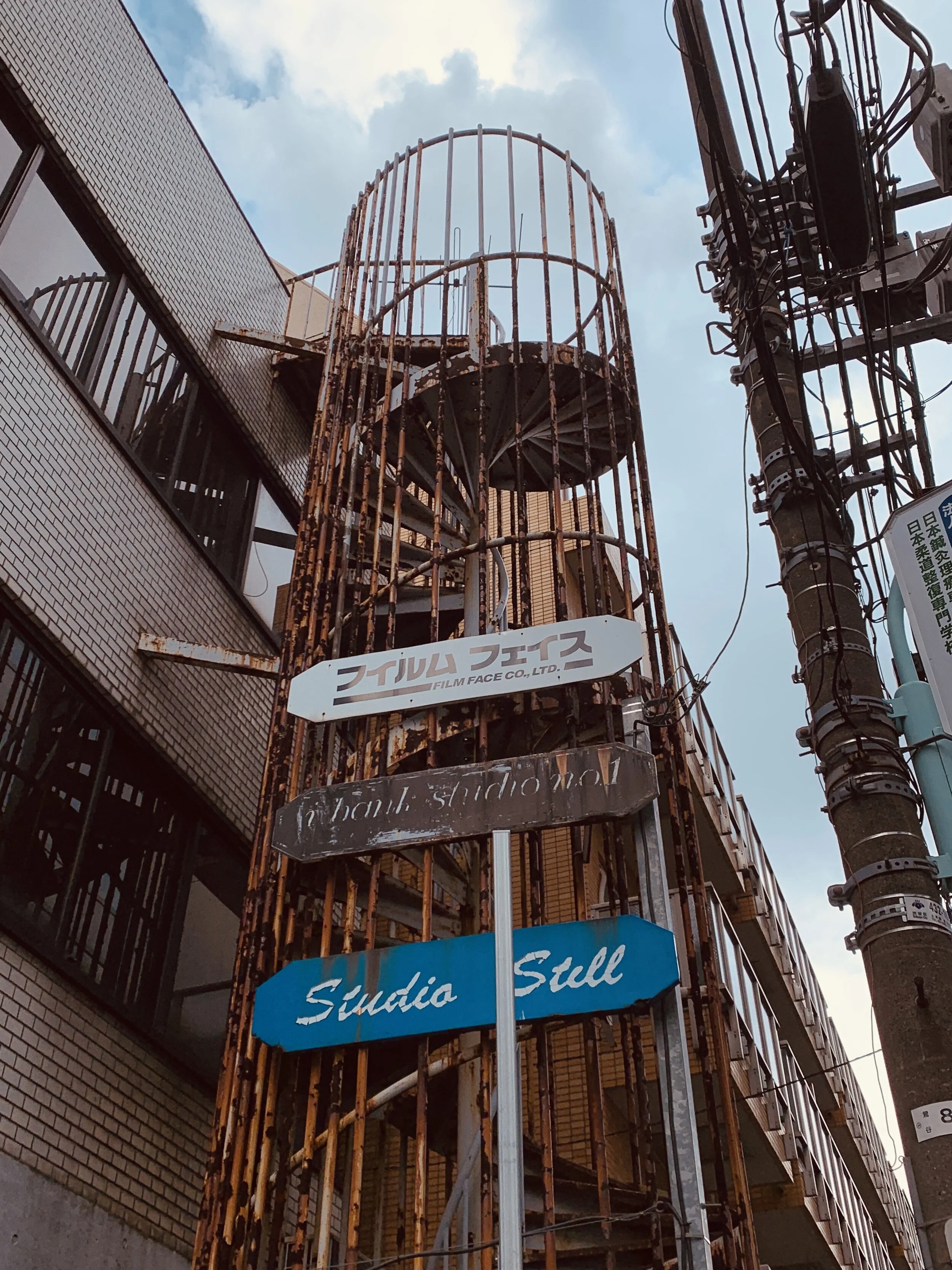  A rust-colored spiral staircase reaching towards the sky in Tokyo 