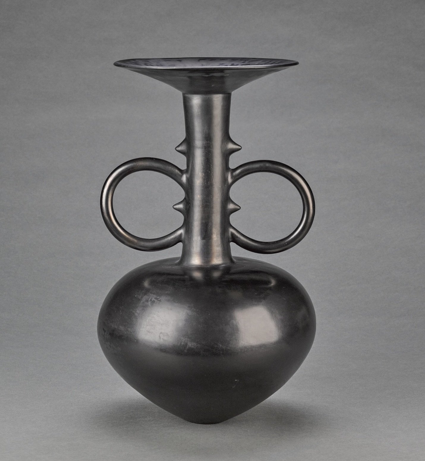 Magdalene Odundo&rsquo;s practice centers on hand-coiled ceramic vessels that fuse traditions from African, Caribbean, and European pottery. Her work embodies a deep reverence for material, process, and cultural memory, creating objects that feel bot