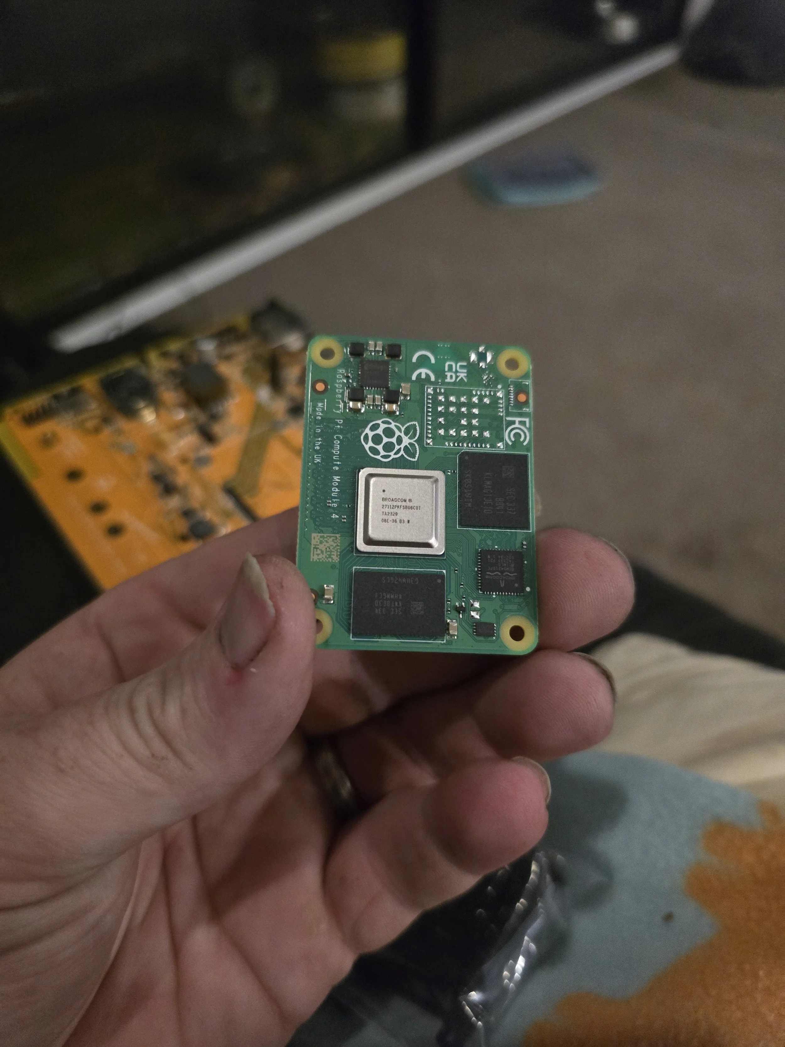 Person holding a Raspberry Pi Compute Module in hand.