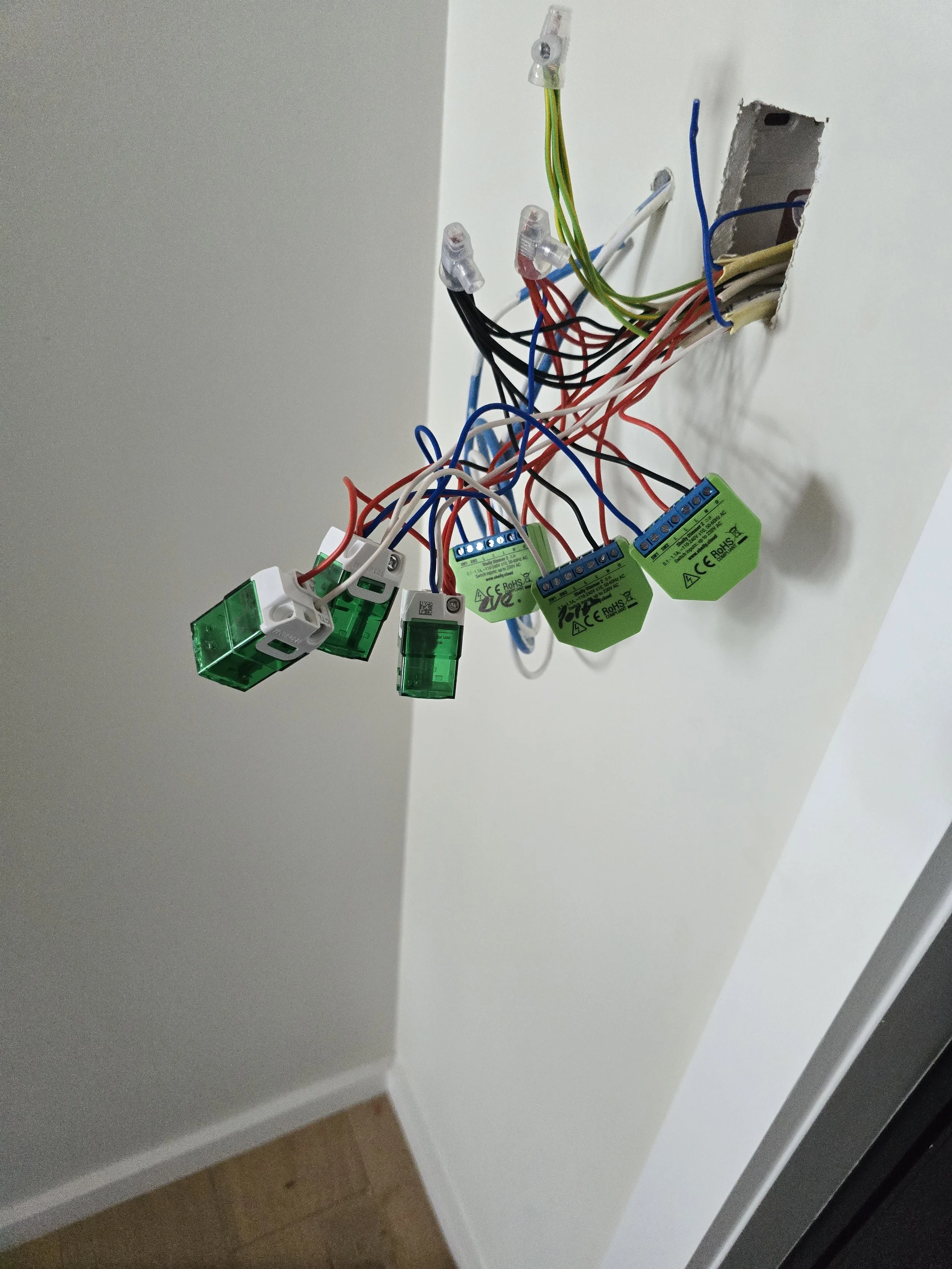 Exposed electrical wires with connectors and relays in a wall cavity