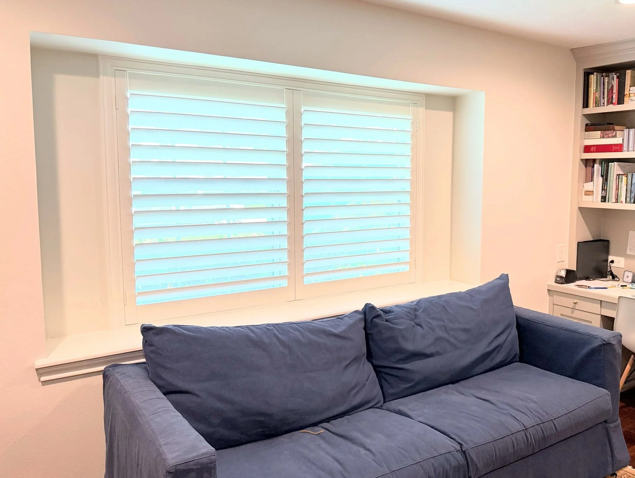 Plantation shutters with 3.5-inch louvers, hidden rear tilt, and a Traditional frame in a Houston home office.
