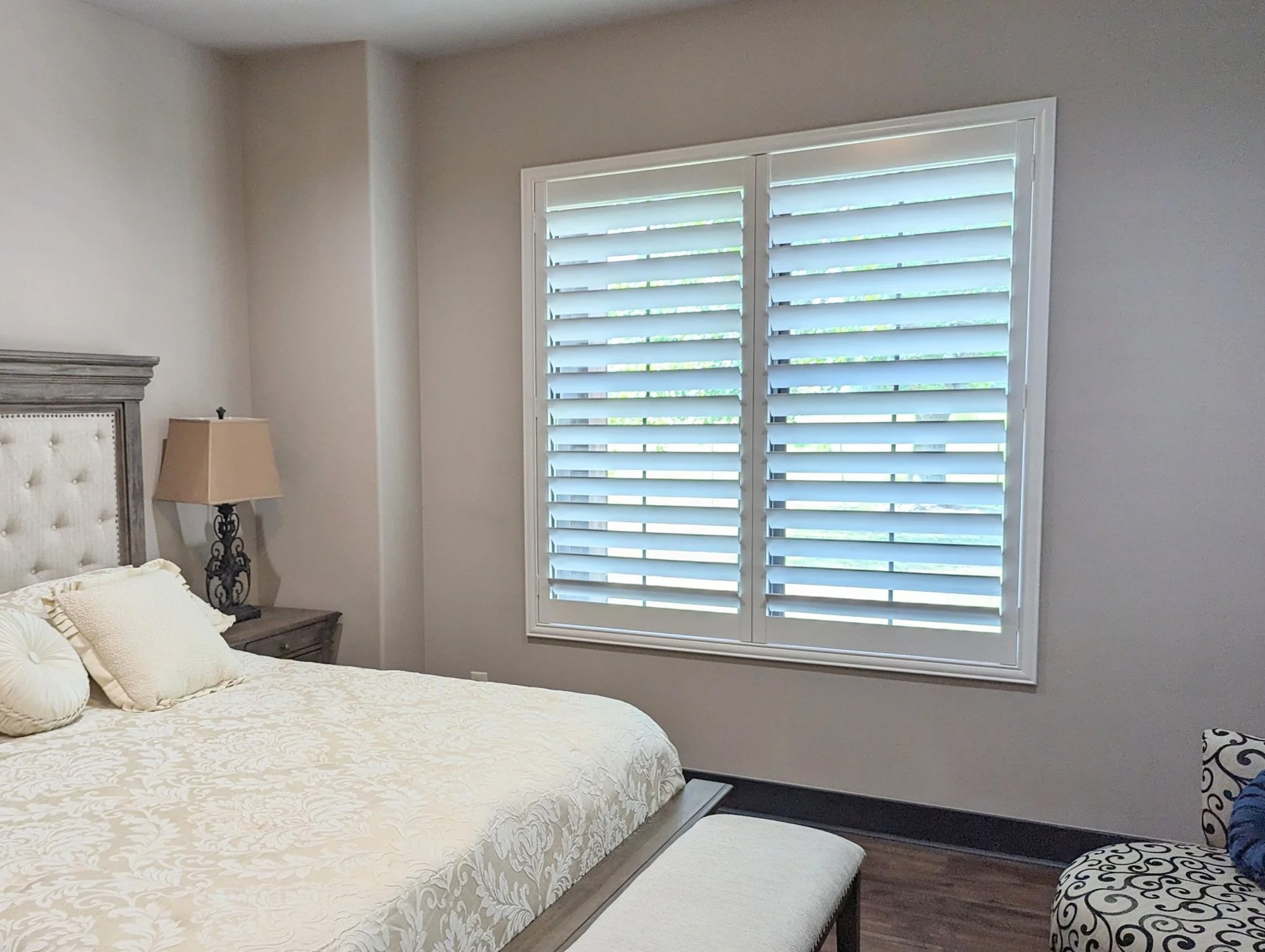 White plantation shutters with 4.5-inch louvers, hidden rear tilt, and a Traditional frame in a Houston bedroom.