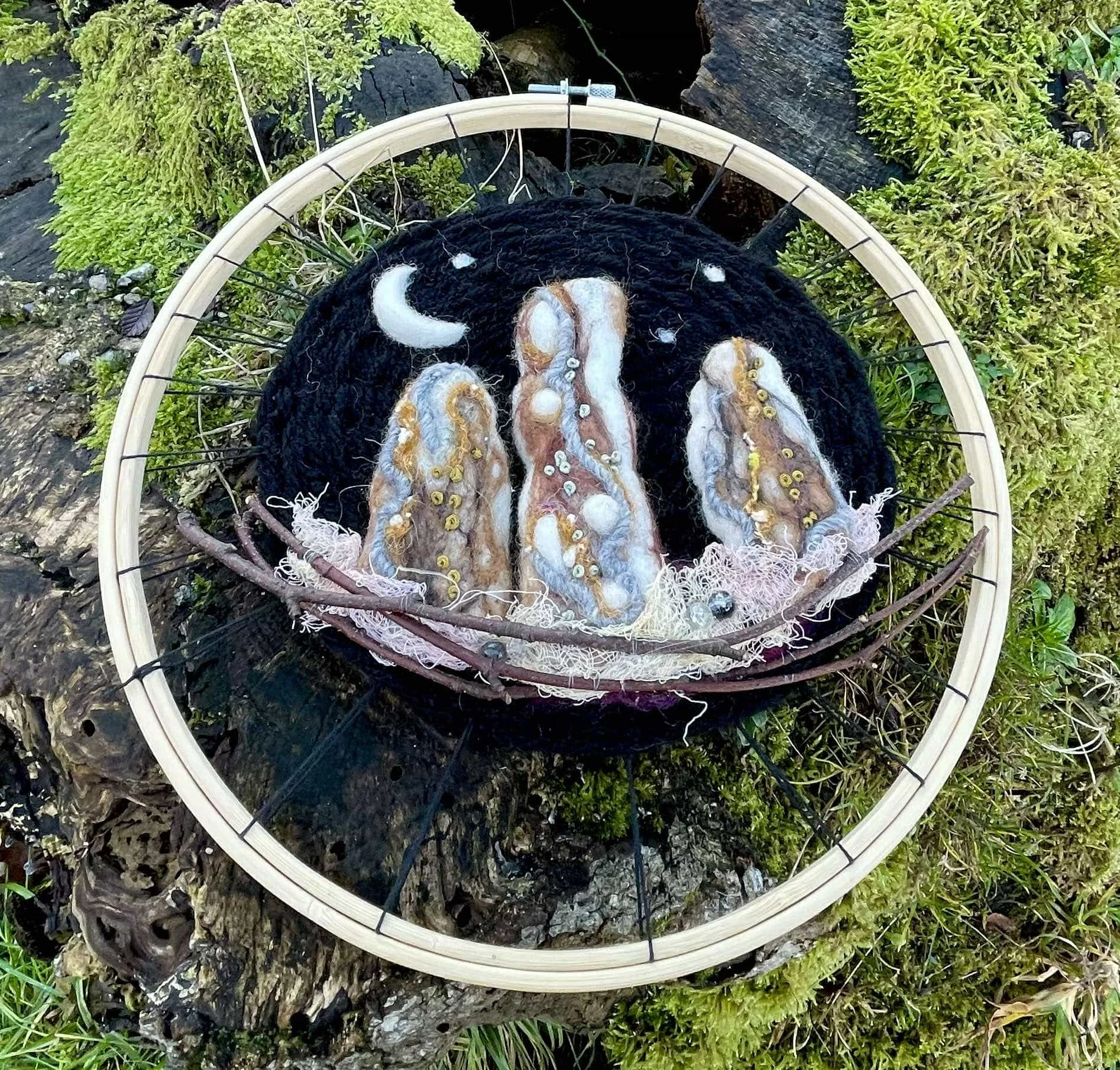 A circular woven artwork inspired by Loch Lomond, featuring a needle-felted standing stone made with natural and recycled materials.  Handmade, and uniquely Scottish sustainable, and uniquely Scottish
