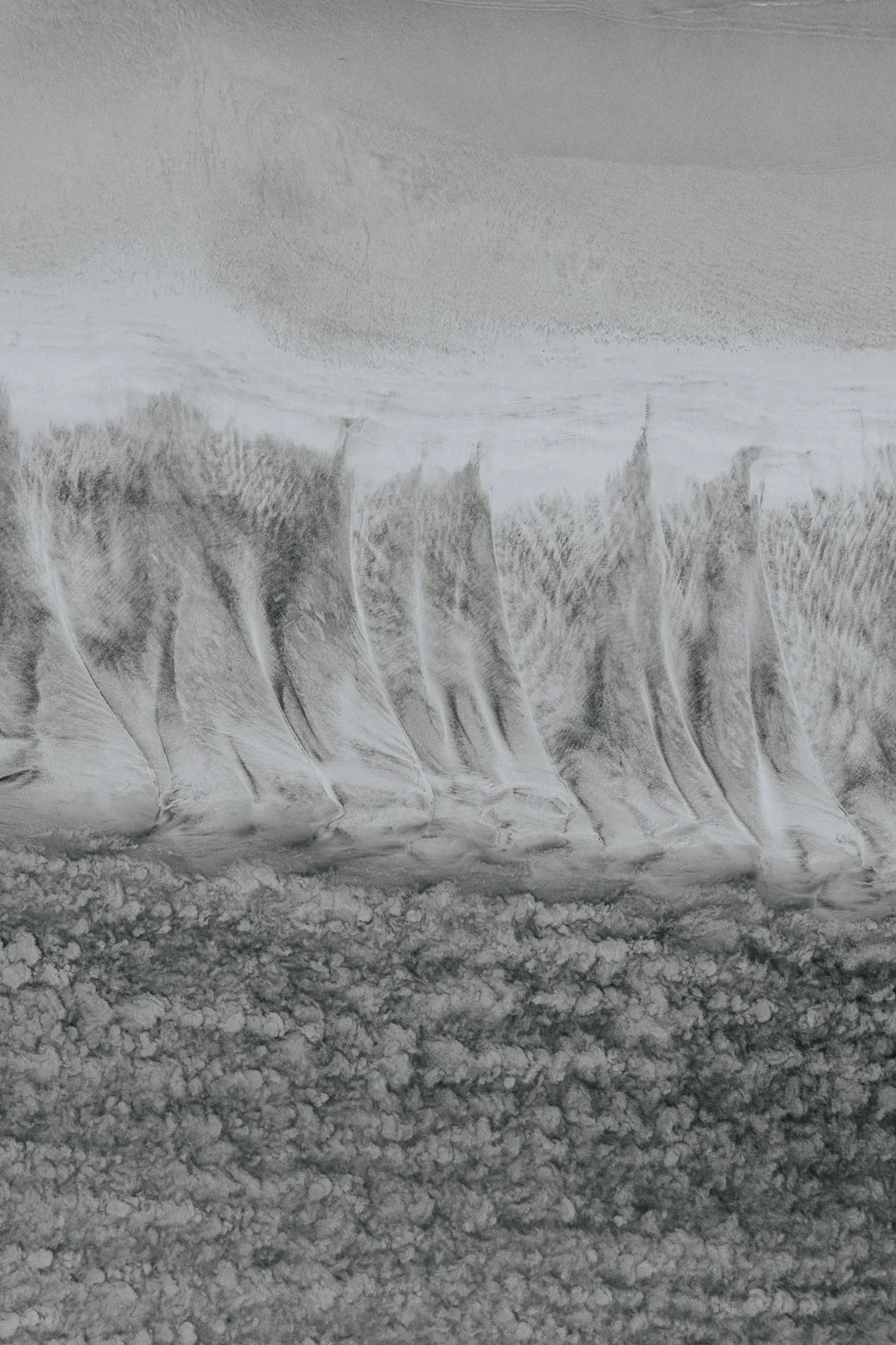 Black and white photograph of a waterfall with cascading water over rocks.