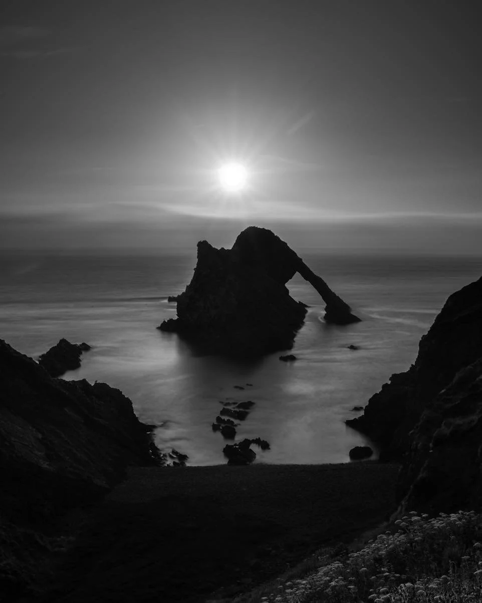 At Bow Fiddle Rock, the sun had only just climbed above the horizon when the light began to turn harsh. Instead of chasing colour, I turned to black and white, letting the silhouette of this striking sea arch in the Moray Firth carry the image. A lon