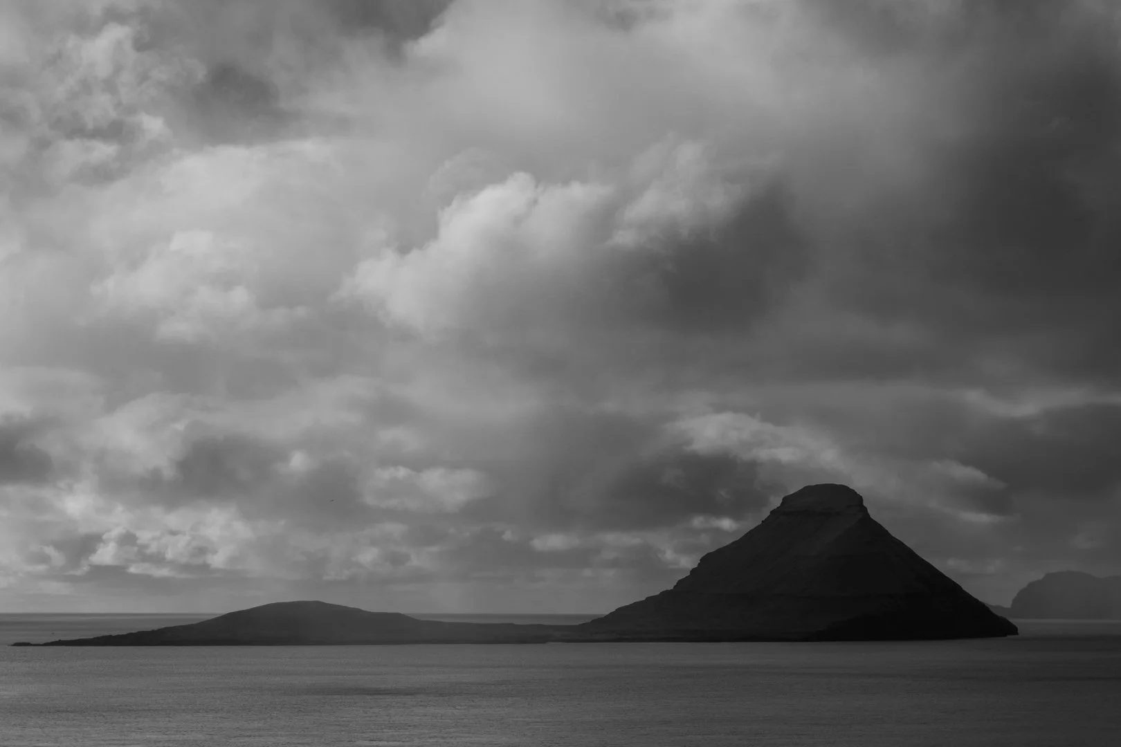 The island of Koltur &ndash; &ldquo;colt&rdquo; &ndash; sits alone in the sea, its single peak watching over the waters. Around its shores, puffins, storm petrels, and other seabirds trace endless paths through wind and rain. Today, a curtain of show