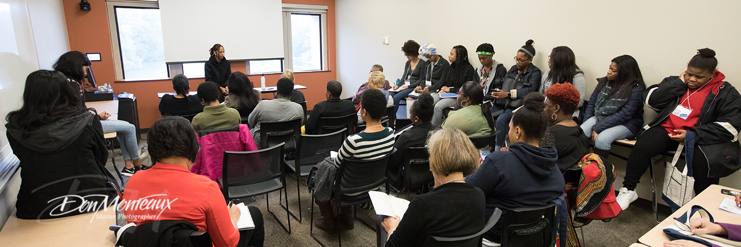 Image of Janaya Khan speaking to a group of students.