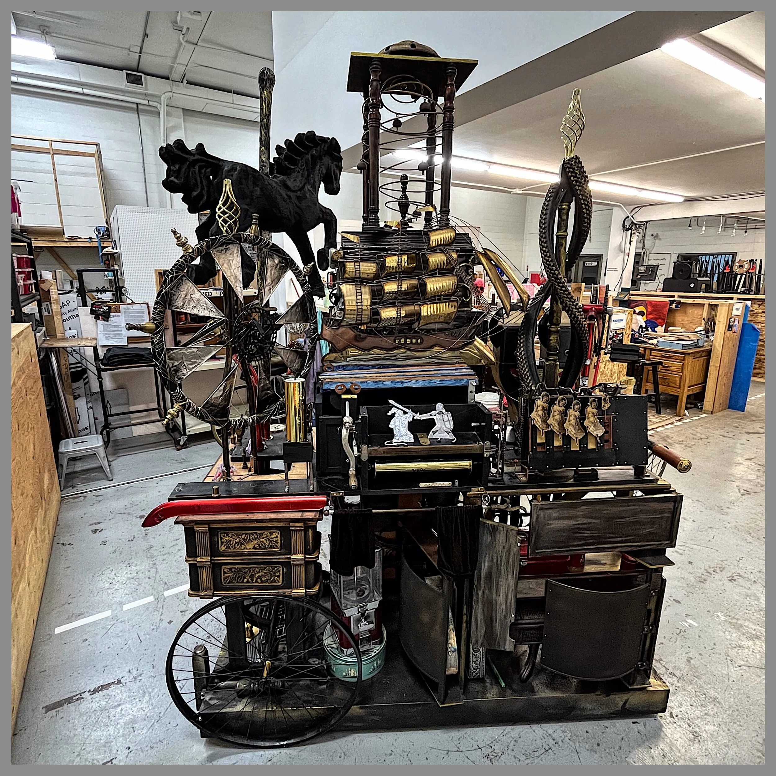 steampunk machine with brass sailing ship, carousel horse, marbles run, bicycle wheels