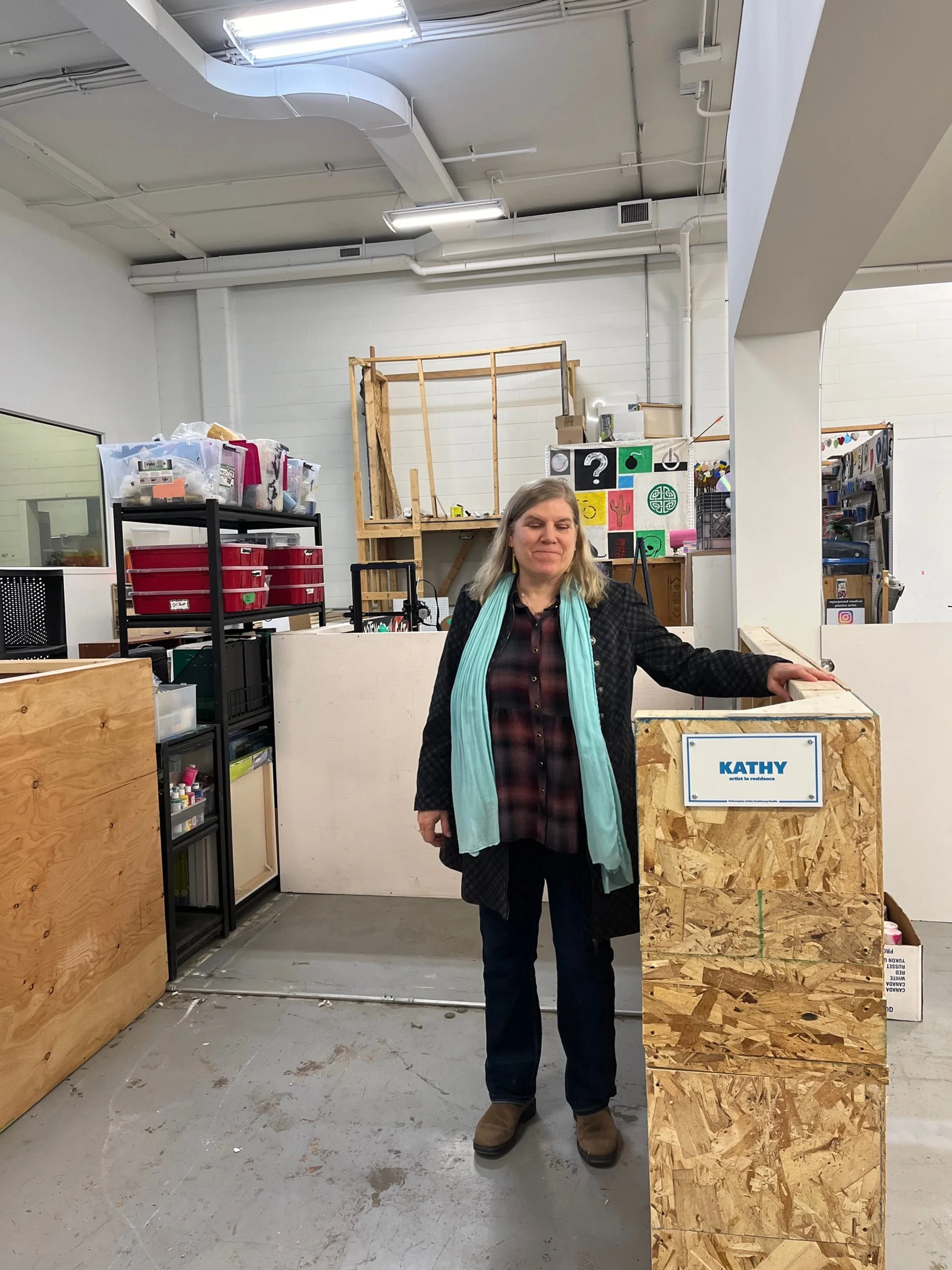 Artist stands in empty 7' x 8' studio space