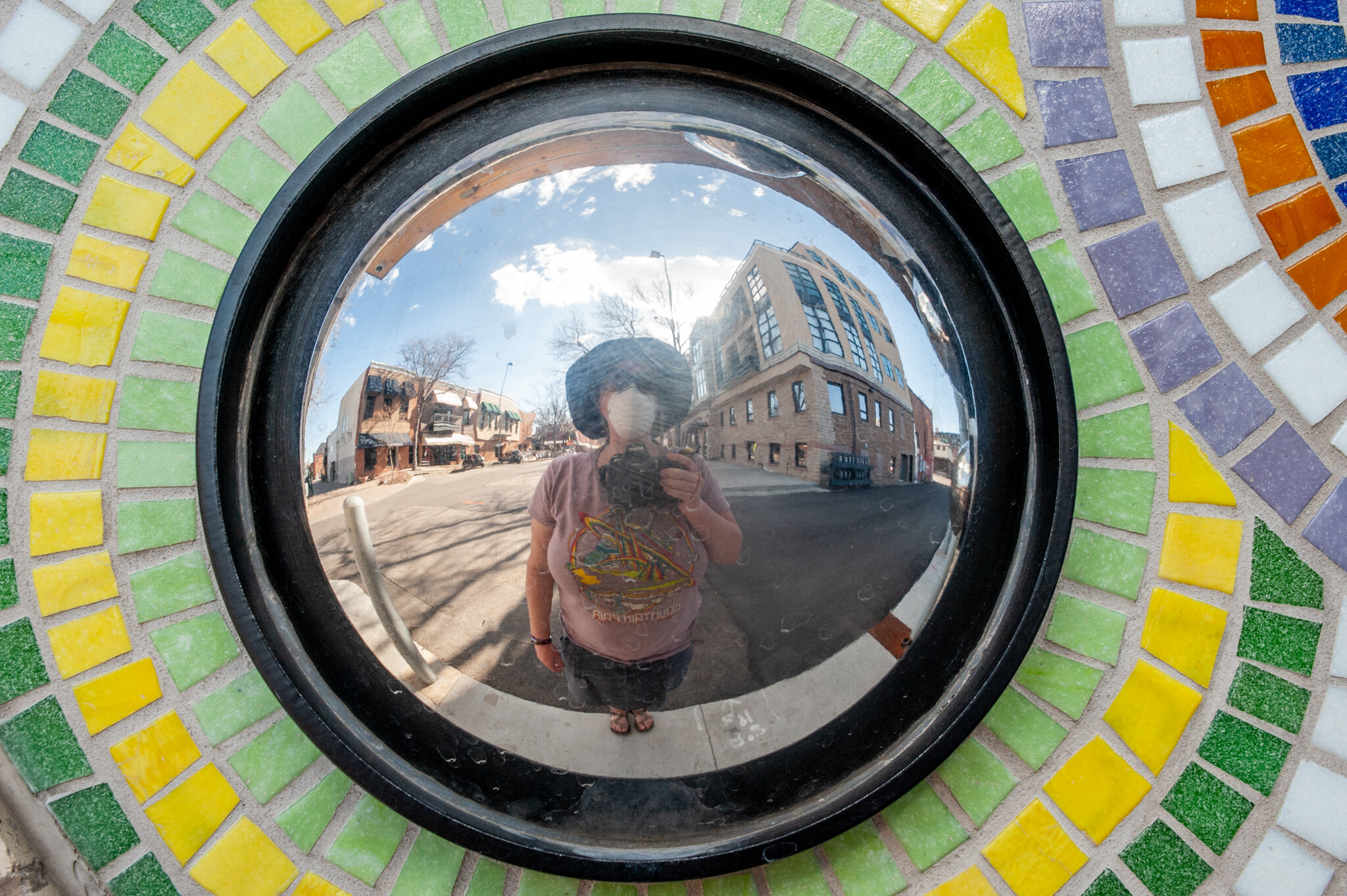  My city is so empty. Though I’ve passed by this public artwork many times, it took the quiet stillness to notice my reflection in part of it. The piece by Joe McGrane is called “Alley Views.”  The photo was taken in Old Town Fort Collins, on April 7