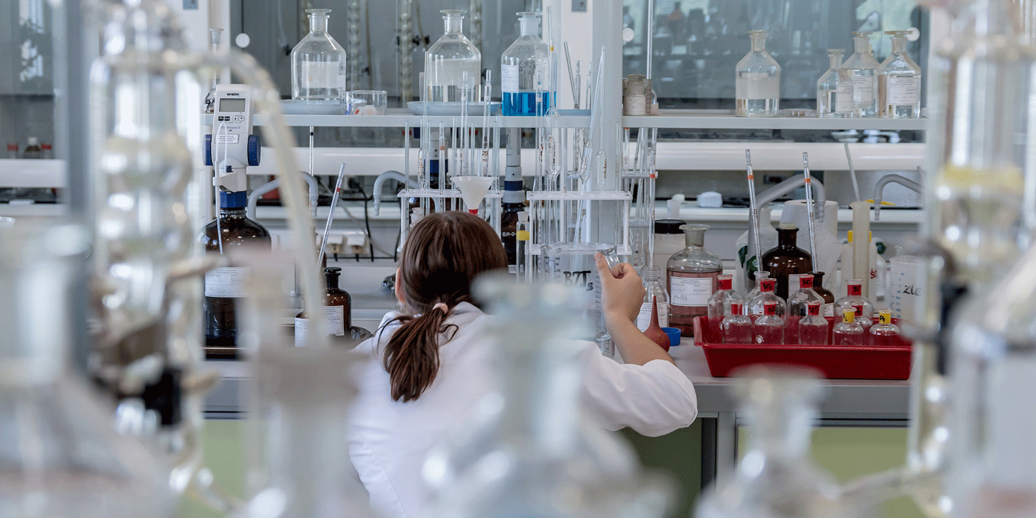 Woman working in a laboratory testing and creating Shower in a Can - creating the little fluffy clouds of foam that disolve dirt and leave you clean and fresh.