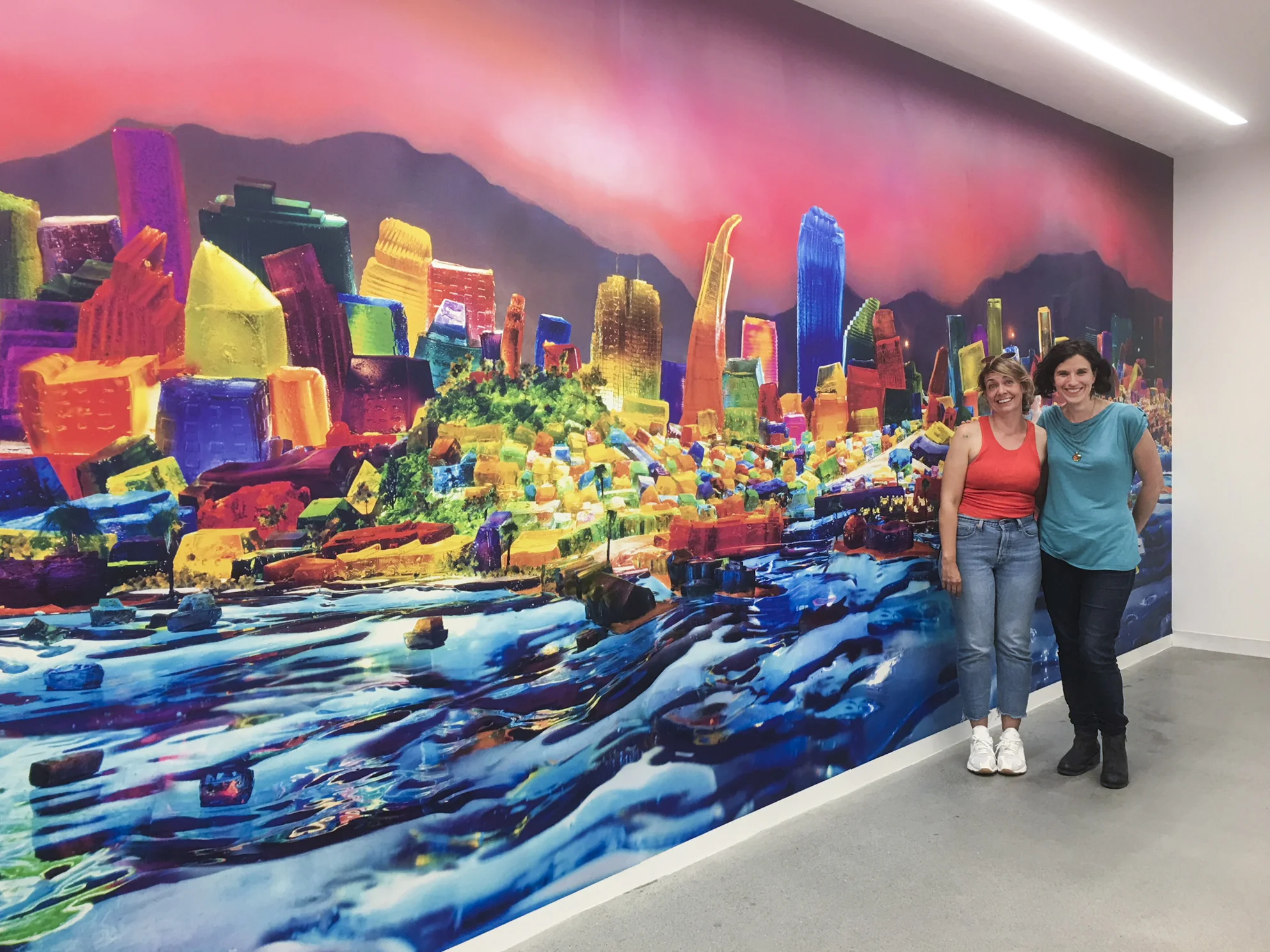 Kristin Farr and Liz Hickok with her installation of her mural “View From Alcatraz” from the “San Francisco in Jell-O” series.