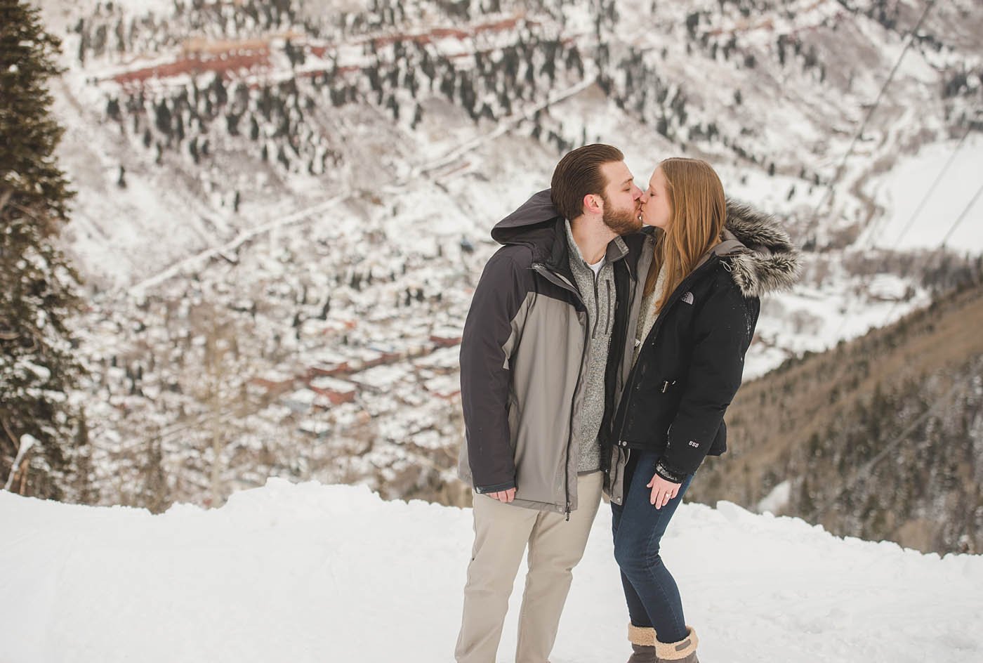 kiss with the town of Telluride below them.