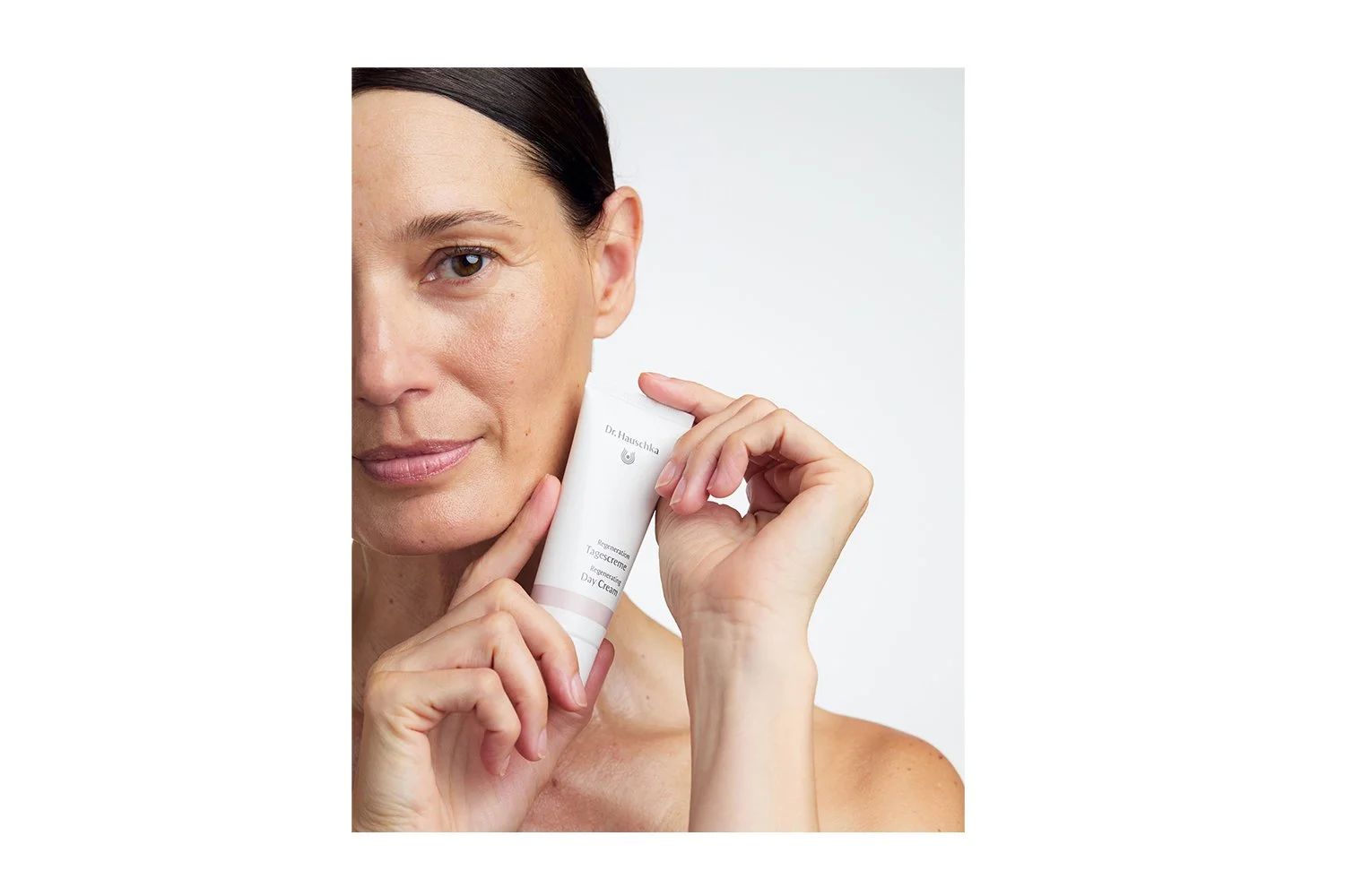Regenerating Day Cream model holding product.jpg