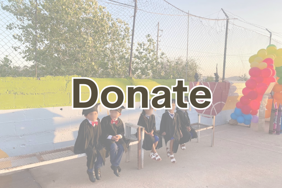 Image young children sitting on a bench and wearing graduation capes and outfits. Text across the image reads "Donate"